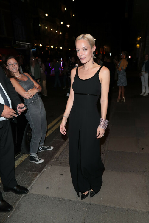 Lily Allen seen leaving the Duke of York's Theatre after her performance in 'The Pillowman' on August 21, 2023 in London, England.

Lily Allen puts on a stylish display in a Giorgio Armani gown as she leaves the theatre after The Pillowman

She's been turning the stage door path into her own personal runway night after night. 

And Lily Allen pulled off another sartorial win on Monday as she left the Duke of York's Theatre in a chic a Giorgio Armani gown after her performance in The Pillowman. 

The singer, 38, looked incredible in a sweeping black dress that cinched in at her slender waist and skimmed out into a full skirt. 

Featuring sequinned embellishment that caught the eye, the garment ensured all eyes would be on her as she left the theatre. 

Adding to the glamour she donned a stack of chunky pink bangles on one arm and slicked her peroxide blonde locks back to expose statement earrings.

The star recently revealed why she changes into glamorous outfits every night to leave the theatre after her performances in The Pillowman.

Lily has been starring in Martin McDonagh's revival of the show at London's Duke Of York Theatre and is often seen strutting home in a series of stylish looks.

In a Q&A one fan asked her: 'Is it a "thing" to get dressed up after your show?! Do you go home & just get changed again?!'

She replied saying that sometimes it helps her transition back after playing the 'harrowing role' but that other times it's just because she feels like 'that b****h'.

Lily penned: 'The role that I'm doing is pretty harrowing. It's nice to come off stage and transition into something glamorous. It really helps me to separate what's happened on stage.

'Plus I'm very lucky and people send me wonderful things to wear. People at the stage door get a nicer picture. And also sometimes I'm just THAT B***CH.'

Lily has been consistently serving her admirers and audience designer, high-fashion looks after finishing up her strenuous performances.

The mother-of-two recently spoken about the challenges she has faced in her demanding role that has kept her away from her loved ones during its ongoing three-month run.

Taking to Instagram, Lily admitted she was battling loneliness as a result, exacerbated by her children's attendance at a summer camp in the United States.

She wrote: 'Hello Monday. 1 month to go of The Pillowman. 

'Missing home, missing my bubbas who are both at summer camp, haven't even spoken to them for 2 weeks! 

'Tired and lonely but the Banya always manages to get my blood going and lift my spirits.'

#LilyAllen