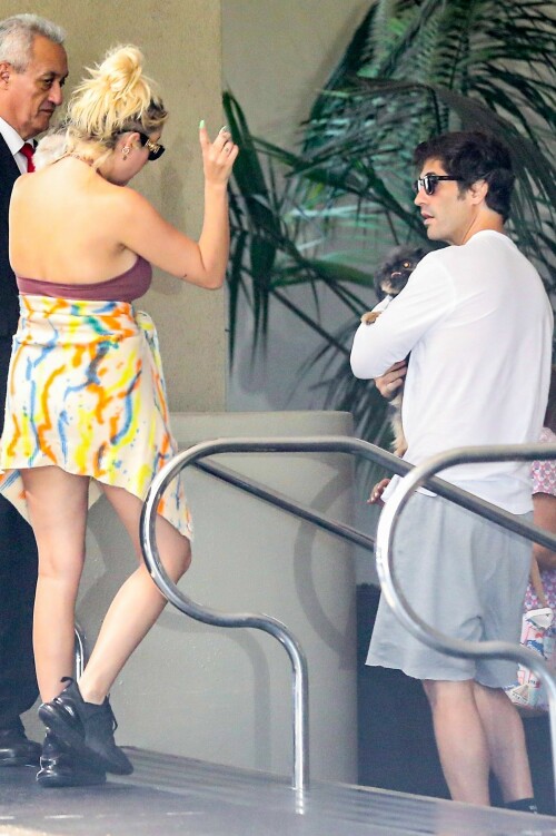 Ashley Benson and Brandon Davis step out for lunch with their puppies in Los Angeles - August 23, 2023

Who Is Ashley Benson's Fiancé? All About Brandon Davis

Ashley Benson and Brandon Davis were first linked in January 2023. They announced their engagement in July 2023

Ashley Benson and Brandon Davis are getting married!

In July 2023, Davis announced their engagement on his Instagram Story, posting a picture of Benson's massive diamond ring. Over the photo, he called Benson "Love of my life."

Benson then reshared the post, captioning it with, “My best frienddddd, I love you.”

The Pretty Little Liars actress and the oil heir first sparked romance rumors in January 2023 after they were spotted sitting courtside at a basketball game. PEOPLE confirmed their relationship in February.

"They have a lot of mutual friends and are both super fun and very social people," said a source close to the couple.

Davis, who is the grandson of billionaire oil tycoon Marvin Davis, has been making headlines long before meeting Benson. In the mid-2000s, he frequently partied with Paris Hilton and briefly dated actress Mischa Barton.

So, who is Ashley Benson's fiancé? Here's everything to know about Brandon Davis.

He is an heir to an oil fortune

The grandson of a billionaire oil tycoon, Davis is an heir to a massive fortune. His grandfather, Marvin Davis, built his wealth through lucrative business deals in both the oil and entertainment industries.

According to his 2004 New York Times obituary, the elder Davis sold his oil holdings in the early 1980s and began investing in entertainment and real estate, acquiring companies such as 20th Century Fox, Pebble Beach Company, the Aspen Skiing Company and the Beverly Hills Hotel.

He has four siblings

Davis has two brothers, Alexander and Jason, and two half-sisters, Mariella and Isabella Rickel, from his mother's second marriage.

Jason Davis, an actor best known for voicing Mikey Blumberg on the ABC animated series Recess, died from a Fentanyl overdose in February 2020 at age 35.

He dated Mischa Barton

Benson isn't Davis' first Hollywood girlfriend. In 2004, he began dating The O.C. actress Mischa Barton after they were introduced at a charity event. Their relationship lasted slightly over a year, and their breakup was confirmed in July 2005.

"They are no longer together but they remain close friends," Barton's publicist, Craig Schneider, told PEOPLE at the time.

Davis confirmed the news via his publicist Ken Sunshine, telling PEOPLE, "I wish her only the best."

He was friends with Paris Hilton

In the mid-2000s, Davis was a close friend of Paris Hilton, and the pair were often seen together at restaurants and nightclubs.

In one snap posted by Hilton in 2013, she and Davis were photographed at a Jay-Z concert along with nightclub owner Richie Akiva. "Killing it at the Jay Z Concert with my crew 🎶❤️🎶👯," Hilton captioned the photo.

He's dabbled in art curation

After his public friendship with Hilton fizzled, Davis spent several years largely out of the public eye. In 2016, he returned by launching an art pop-up in Beverly Hills. The show was titled "Malpais" and featured works by Mexican artist Bosco Sodi.

"I love Bosco's work. It reminds me of Yves Klein, an artist I grew up loving, and it has its own feel. It's unique in its own way," he told The Hollywood Reporter in 2016. "I'm just following my passion. I've been an art collector for many years. I've been transitioning into the launch of Brandon Davis Projects. I see an opportunity to bring artists that don't have representation to L.A. and to potential other cities."

He and Benson were first linked in January 2023

Davis and Benson sparked romance rumors when they sat courtside at a Los Angeles Lakers basketball game together in January 2023. The couple was seen laughing and smiling, with Davis' arm slung over Benson's leg.

They also attended a friend's birthday party together and, in early February, were photographed on a double date with actress Emma Roberts and her boyfriend Cody John, in photos obtained by Just Jared.

His relationship with Benson was confirmed in February 2023

In February 2023, PEOPLE exclusively confirmed Davis and Benson's relationship. However, the two have largely kept their relationship private.

"I usually keep my relationships private," Benson told Cosmopolitan UK in 2021, shortly after her breakup with rapper G-Eazy. "You obviously can't help if you get photographed together. [But] it's more sacred that way. Those private moments are for you and your partner, and I think it's best not to be over-exposed, and you can really protect your relationship if you're not exploiting it."

Before her relationship with the "Him & I" artist, Benson dated model and actress Cara Delevigne for two years.

He and Benson announced their engagement in July 2023

In July 2023, Davis announced the couple's engagement when he posted a photo on his Instagram Story of Benson wearing a massive diamond on her ring finger. "Love of my life," he wrote over the snap.

Benson reshared the post, writing, “My best frienddddd, I love you.”

The actress also reposted actress Theresa Picciallo’s Instagram Story, which showed Benson showing off her ring during a video call. “Our babies are getting married!!!!!!" Picciallo wrote over the snap. "@ashleybenson & @brandondavis1111, we love you both unconditionally, endlessly, forever and always. Congratulations to out best friends!!!”

people.com

#AshleyBenson