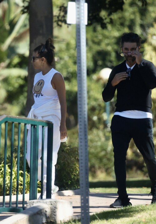 Eva Longoria | Spotted at the Park in Los Angeles - August 27, 2023

Eva Longoria enjoys some quality time with her husband and José Bastón and son Santiago, five, at the park in LA

Eva Longoria looked relaxed as she spent some time with her family in Los Angeles.

The actress, 48, who mixed and mingled at a charity function with Kim Kardashian and other celebrities on Saturday night, showcased her toned arms in a sleeveless white T-shirt with a smiley face and the initials LAFC.

The Flamin' Hot director completed her look with a pair of white jeans and sneakers.

She tied a white sweatshirt around her waist.

The Land of Women star wore her long, dark hair in a high bun and appeared to be wearing natural looking makeup.

She completed the look with a pair of dark sunglasses.

The Unplugging actress was joined by her husband, Jose Baston, 55, who looked dapper in a black sweater, joggers and sneakers.

The hem of a white T-shirt peaked beneath his sweater.

Their son, Santiago, five, looked adorable in a sky blue golf shirt and shorts.

On Sunday morning, Eva flaunted her toned curves in a jaw dropping swimsuit shot on social media.

The Texas-born beauty wore a canary yellow one-piece with a plunging halter top and French cut legs as she strolled along the beach carrying a wine glass.

She donned a yellow cover up and allowed the wind to tousle her dark locks for the shot.

The savvy businesswoman typed 'My summer secrets?' in yellow across the snap and then provided a link to the Instagram account for InMode Aesthetics.

The company provides high end skin care and treatments that include micro needling, laser treatments and other procedures.

In addition to supporting the This is About Humanity organization, which focuses on reuniting families who have been separated at the US-Mexico border, Ava has spent some of her time helping to raise money for survivors of the Maui fires.

The Casa Del Sol Tequila founder poured drinks Friday at a fundraiser in Santa Monica with proceeds going to helping Maui residents.

'What a night!' she wrote on Instagram next to a highlight video.

'I love anything that supports a good cause.'

DailyMail

#EvaLongoria