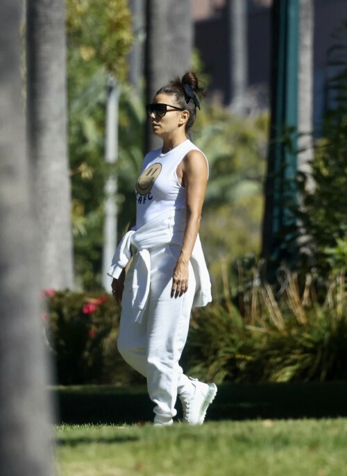 Eva Longoria | Spotted at the Park in Los Angeles - August 27, 2023

Eva Longoria enjoys some quality time with her husband and José Bastón and son Santiago, five, at the park in LA

Eva Longoria looked relaxed as she spent some time with her family in Los Angeles.

The actress, 48, who mixed and mingled at a charity function with Kim Kardashian and other celebrities on Saturday night, showcased her toned arms in a sleeveless white T-shirt with a smiley face and the initials LAFC.

The Flamin' Hot director completed her look with a pair of white jeans and sneakers.

She tied a white sweatshirt around her waist.

The Land of Women star wore her long, dark hair in a high bun and appeared to be wearing natural looking makeup.

She completed the look with a pair of dark sunglasses.

The Unplugging actress was joined by her husband, Jose Baston, 55, who looked dapper in a black sweater, joggers and sneakers.

The hem of a white T-shirt peaked beneath his sweater.

Their son, Santiago, five, looked adorable in a sky blue golf shirt and shorts.

On Sunday morning, Eva flaunted her toned curves in a jaw dropping swimsuit shot on social media.

The Texas-born beauty wore a canary yellow one-piece with a plunging halter top and French cut legs as she strolled along the beach carrying a wine glass.

She donned a yellow cover up and allowed the wind to tousle her dark locks for the shot.

The savvy businesswoman typed 'My summer secrets?' in yellow across the snap and then provided a link to the Instagram account for InMode Aesthetics.

The company provides high end skin care and treatments that include micro needling, laser treatments and other procedures.

In addition to supporting the This is About Humanity organization, which focuses on reuniting families who have been separated at the US-Mexico border, Ava has spent some of her time helping to raise money for survivors of the Maui fires.

The Casa Del Sol Tequila founder poured drinks Friday at a fundraiser in Santa Monica with proceeds going to helping Maui residents.

'What a night!' she wrote on Instagram next to a highlight video.

'I love anything that supports a good cause.'

DailyMail

#EvaLongoria