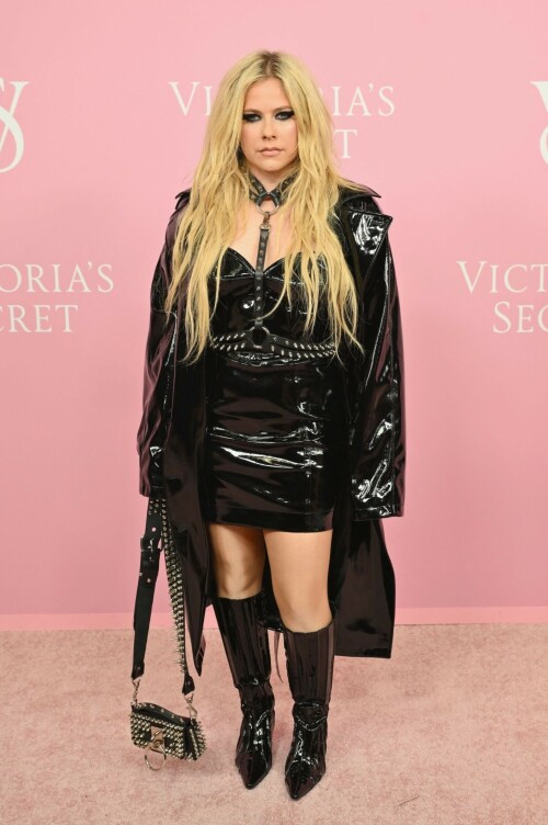 Avril Lavigne | Victoria's Secret Celebrates The Tour '23 at The Manhattan Center New York City - September 6, 2023

Avril Lavigne is a 'Canadian queen' in latest punk photos from New York: 'A goddess'

The "Complicated" songstress walked the pink carpet at the Victoria's Secret World Tour in Manhattan.

Avril Lavigne is bringing a touch of punk south of the border.

The 38-year-old Canadian songstress took to Instagram on Wednesday with a carousel of photos taken inside a vehicle as she visited New York.

In the first shot, the "Complicated" and "Girlfriend" singer posed while sitting on one of the seats, as she dangled a wine glass in her left hand. Lavigne rocked an all-black shiny leather look, which included a long jacket and a strapless mini dress. She paired the fit with a matching studded mini bag, knee-high boots and a studded choker body piece.

Photographed by Tyler Kenny, styled by Lyn Alyson and glammed up by makeup artist Julia Dantas, Lavigne stepped out in style as she kicked off New York Fashion Week.

"NYC baby," the singer captioned her post on Instagram, along with two white heart emojis.

Fellow celebrities and fans showed their appreciation for Lavigne's stunning beauty and edgy style in the comments section.

"Canadian queen," shared fellow Ontario-born icon, model Winnie Harlow.

"Hottest rockstar of the century," one fan wrote.

"God, you're gorgeous, and I love you. Love from Brazil," another added.

"Avril, you look like you throw the best parties," someone raved.

"Literally stunning, Av," someone else penned.

"Looking hot as ever!!" a fan chimed in.

Lavigne wore the chic look at Victoria's Secret's event on Wednesday at the Manhattan Center, ahead of New York Fashion Week, which runs from Sept. 7 to 13 this year.

The lingerie brand held its special event, which included a star-studded pink carpet, to celebrate the upcoming release of "The Victoria's Secret World Tour" on Sept. 26. Releasing on Prime Video, it's the return of the brand's iconic fashion show, this time a feature-length film.

Naomi Campbell, Gigi Hadid, Adriana Lima and Priyanka Chopra were among the celebrities who attended the event. But some Canadians might be most excited to see Lavigne pose beside her Ontario-born sister, model Winnie Harlow, who also made an appearance at the event.

news.yahoo.com

#AvrilLavigne