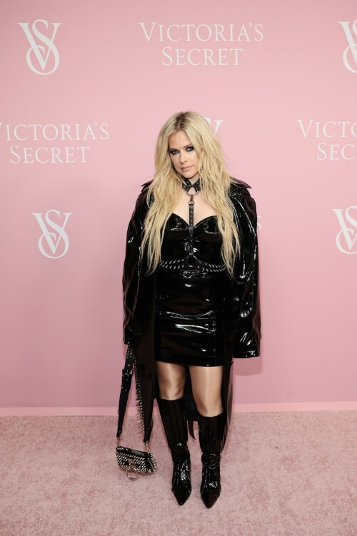 Avril Lavigne | Victoria's Secret Celebrates The Tour '23 at The Manhattan Center New York City - September 6, 2023

Avril Lavigne is a 'Canadian queen' in latest punk photos from New York: 'A goddess'

The "Complicated" songstress walked the pink carpet at the Victoria's Secret World Tour in Manhattan.

Avril Lavigne is bringing a touch of punk south of the border.

The 38-year-old Canadian songstress took to Instagram on Wednesday with a carousel of photos taken inside a vehicle as she visited New York.

In the first shot, the "Complicated" and "Girlfriend" singer posed while sitting on one of the seats, as she dangled a wine glass in her left hand. Lavigne rocked an all-black shiny leather look, which included a long jacket and a strapless mini dress. She paired the fit with a matching studded mini bag, knee-high boots and a studded choker body piece.

Photographed by Tyler Kenny, styled by Lyn Alyson and glammed up by makeup artist Julia Dantas, Lavigne stepped out in style as she kicked off New York Fashion Week.

"NYC baby," the singer captioned her post on Instagram, along with two white heart emojis.

Fellow celebrities and fans showed their appreciation for Lavigne's stunning beauty and edgy style in the comments section.

"Canadian queen," shared fellow Ontario-born icon, model Winnie Harlow.

"Hottest rockstar of the century," one fan wrote.

"God, you're gorgeous, and I love you. Love from Brazil," another added.

"Avril, you look like you throw the best parties," someone raved.

"Literally stunning, Av," someone else penned.

"Looking hot as ever!!" a fan chimed in.

Lavigne wore the chic look at Victoria's Secret's event on Wednesday at the Manhattan Center, ahead of New York Fashion Week, which runs from Sept. 7 to 13 this year.

The lingerie brand held its special event, which included a star-studded pink carpet, to celebrate the upcoming release of "The Victoria's Secret World Tour" on Sept. 26. Releasing on Prime Video, it's the return of the brand's iconic fashion show, this time a feature-length film.

Naomi Campbell, Gigi Hadid, Adriana Lima and Priyanka Chopra were among the celebrities who attended the event. But some Canadians might be most excited to see Lavigne pose beside her Ontario-born sister, model Winnie Harlow, who also made an appearance at the event.

news.yahoo.com

#AvrilLavigne