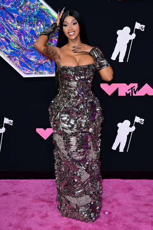 Cardi B | 2023 MTV Video Music Awards in Newark, New Jersey - September 12, 2023

Cardi B’s Metallic VMAs Gown Is Actually Made Up of Hundreds of Silver Hair Clips

Here’s to never having to worry about losing your bobby pin!

Cardi B—unsurprisingly—turned heads with her bold red-carpet ensemble for the 2023 MTV Video Music Awards.

The rapper showed up to New Jersey’s Prudential Center wearing a form-fitting strapless gown that, at first glance, appeared to be made up of glimmering metal shards. However, upon closer inspection, it turned out Cardi’s armorlike Dilara Findikoglu dress was actually covered in hundreds of silver hair clips, stacked and arranged in swirling and fanning patterns. She continued the theme with a pair of black arm cuffs, also studded with hair clips, and further accessorized with glittery heels and a metallic manicure.

Cardi has one nomination for tonight’s awards, in the category of Best Hip-Hop, for her collaboration with GloRilla on “Tomorrow 2.” She’ll also be among the ceremony’s performers, taking the stage with Megan Thee Stallion for their debut performance of “Bongos,” which just dropped on September 8. The duo last collaborated together on the viral “WAP,” back in 2020.

Cardi spoke about the new collab during a guest appearance on the Whoo’s House podcast.

“I wonder how people are gonna react to this vibe because they’re really like expecting ‘WAP,’ like, ‘Oh, here they go again talking this and that,'” Cardi said to host DJ Whoo Kid, per Billboard. “We are talking a little, you know, about some p—y, but not like ‘WAP’ type of stuff.”

Of the forthcoming “Bongos” music video, she added: “It’s a different theme and the video is like a whole complete different type of theme. … It’s like on some ‘b—h, you jump, I jump … if you wit it, I I wit it. We’re gonna do it.’ We worked so hard on the music video. You’re gonna see … that’s thought put into that.”

Other expected performers for tonight’s show include Demi Lovato, Shakira, Doja Cat, Anitta, Olivia Rodrigo, and Sabrina Carpenter.

harpersbazaar.com

#CardiB #vmas