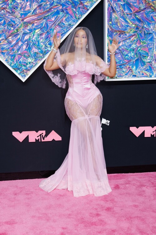 Nicki Minaj | 2023 MTV Video Music Awards in Newark, New Jersey - September 12, 2023

Nicki Minaj Is a Bridal Barbie at the 2023 MTV VMAs

She channeled romance while returning to host this year’s show

Nicki Minaj returned to her Barbiecore roots at the 2023 MTV Video Music Awards.

The rapper—who dubbed herself “Barbie” long before the doll took over the globe this year—made a grand appearance on this year’s red carpet at the Prudential Center in Newark, New Jersey. The star put her own romantic spin on lingerie dressing in a pale pink gown by Dolce & Gabbana, which featured a strapless satin bodysuit and a sheer lace mermaid skirt that fanned out into a circular train. A matching see-through veil with lace trim completed the look.

The rapper finished the monochromatic ensemble with floral-shaped earrings, a diamond tennis bracelet, and an array of diamond rings. Her opulent glam look included a sparkling eye look with pink shadow and sharp cat-eye liner, as well as a nude lip and extra-long bejeweled pink nails.

Minaj is up for six awards tonight, including Artist of the Year and Video of the Year. The host is also set to take the stage twice to perform, both as a solo act and as part of the night’s tribute to hip-hop’s 50th anniversary. For the latter, she will join Lil Wayne, Darryl “DMC” McDaniels, Doug E. Fresh, Grandmaster Flash and the Furious Five, and LL Cool J.

At last year’s awards, Minaj received the Video Vanguard Award and treated the audience to a mash-up performance of hits including “Monster,” “Moment 4 Life,” and “Anaconda.” She transformed the VMAs stage into a Barbie DreamHouse in a tribute to her fans, the Barbz, complete with a matching Barbiecore look composed of a bedazzled corset with crystal-covered sleeves, a flared light-pink skirt, and black platform boots with hot-pink laces.

harpersbazaar

#NickiMinaj #vmas