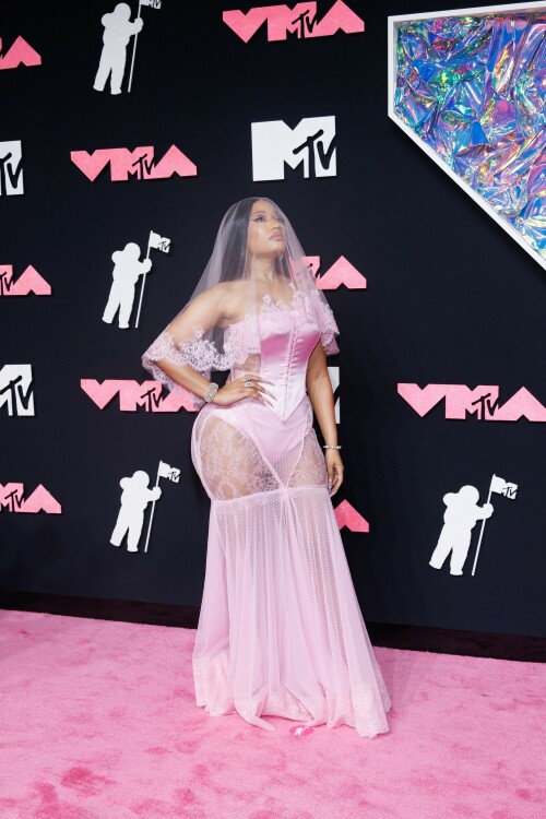 Nicki Minaj | 2023 MTV Video Music Awards in Newark, New Jersey - September 12, 2023

Nicki Minaj Is a Bridal Barbie at the 2023 MTV VMAs

She channeled romance while returning to host this year’s show

Nicki Minaj returned to her Barbiecore roots at the 2023 MTV Video Music Awards.

The rapper—who dubbed herself “Barbie” long before the doll took over the globe this year—made a grand appearance on this year’s red carpet at the Prudential Center in Newark, New Jersey. The star put her own romantic spin on lingerie dressing in a pale pink gown by Dolce & Gabbana, which featured a strapless satin bodysuit and a sheer lace mermaid skirt that fanned out into a circular train. A matching see-through veil with lace trim completed the look.

The rapper finished the monochromatic ensemble with floral-shaped earrings, a diamond tennis bracelet, and an array of diamond rings. Her opulent glam look included a sparkling eye look with pink shadow and sharp cat-eye liner, as well as a nude lip and extra-long bejeweled pink nails.

Minaj is up for six awards tonight, including Artist of the Year and Video of the Year. The host is also set to take the stage twice to perform, both as a solo act and as part of the night’s tribute to hip-hop’s 50th anniversary. For the latter, she will join Lil Wayne, Darryl “DMC” McDaniels, Doug E. Fresh, Grandmaster Flash and the Furious Five, and LL Cool J.

At last year’s awards, Minaj received the Video Vanguard Award and treated the audience to a mash-up performance of hits including “Monster,” “Moment 4 Life,” and “Anaconda.” She transformed the VMAs stage into a Barbie DreamHouse in a tribute to her fans, the Barbz, complete with a matching Barbiecore look composed of a bedazzled corset with crystal-covered sleeves, a flared light-pink skirt, and black platform boots with hot-pink laces.

harpersbazaar

#NickiMinaj #vmas