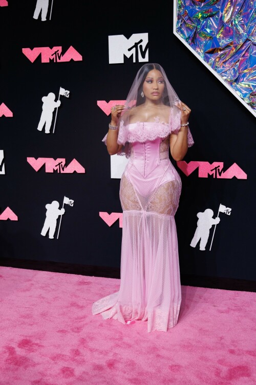 Nicki Minaj | 2023 MTV Video Music Awards in Newark, New Jersey - September 12, 2023

Nicki Minaj Is a Bridal Barbie at the 2023 MTV VMAs

She channeled romance while returning to host this year’s show

Nicki Minaj returned to her Barbiecore roots at the 2023 MTV Video Music Awards.

The rapper—who dubbed herself “Barbie” long before the doll took over the globe this year—made a grand appearance on this year’s red carpet at the Prudential Center in Newark, New Jersey. The star put her own romantic spin on lingerie dressing in a pale pink gown by Dolce & Gabbana, which featured a strapless satin bodysuit and a sheer lace mermaid skirt that fanned out into a circular train. A matching see-through veil with lace trim completed the look.

The rapper finished the monochromatic ensemble with floral-shaped earrings, a diamond tennis bracelet, and an array of diamond rings. Her opulent glam look included a sparkling eye look with pink shadow and sharp cat-eye liner, as well as a nude lip and extra-long bejeweled pink nails.

Minaj is up for six awards tonight, including Artist of the Year and Video of the Year. The host is also set to take the stage twice to perform, both as a solo act and as part of the night’s tribute to hip-hop’s 50th anniversary. For the latter, she will join Lil Wayne, Darryl “DMC” McDaniels, Doug E. Fresh, Grandmaster Flash and the Furious Five, and LL Cool J.

At last year’s awards, Minaj received the Video Vanguard Award and treated the audience to a mash-up performance of hits including “Monster,” “Moment 4 Life,” and “Anaconda.” She transformed the VMAs stage into a Barbie DreamHouse in a tribute to her fans, the Barbz, complete with a matching Barbiecore look composed of a bedazzled corset with crystal-covered sleeves, a flared light-pink skirt, and black platform boots with hot-pink laces.

harpersbazaar

#NickiMinaj #vmas