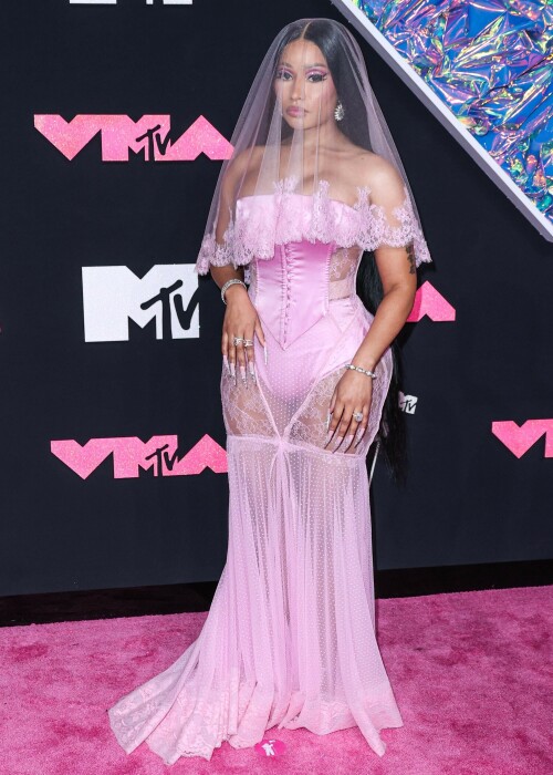 Nicki Minaj | 2023 MTV Video Music Awards in Newark, New Jersey - September 12, 2023

Nicki Minaj Is a Bridal Barbie at the 2023 MTV VMAs

She channeled romance while returning to host this year’s show

Nicki Minaj returned to her Barbiecore roots at the 2023 MTV Video Music Awards.

The rapper—who dubbed herself “Barbie” long before the doll took over the globe this year—made a grand appearance on this year’s red carpet at the Prudential Center in Newark, New Jersey. The star put her own romantic spin on lingerie dressing in a pale pink gown by Dolce & Gabbana, which featured a strapless satin bodysuit and a sheer lace mermaid skirt that fanned out into a circular train. A matching see-through veil with lace trim completed the look.

The rapper finished the monochromatic ensemble with floral-shaped earrings, a diamond tennis bracelet, and an array of diamond rings. Her opulent glam look included a sparkling eye look with pink shadow and sharp cat-eye liner, as well as a nude lip and extra-long bejeweled pink nails.

Minaj is up for six awards tonight, including Artist of the Year and Video of the Year. The host is also set to take the stage twice to perform, both as a solo act and as part of the night’s tribute to hip-hop’s 50th anniversary. For the latter, she will join Lil Wayne, Darryl “DMC” McDaniels, Doug E. Fresh, Grandmaster Flash and the Furious Five, and LL Cool J.

At last year’s awards, Minaj received the Video Vanguard Award and treated the audience to a mash-up performance of hits including “Monster,” “Moment 4 Life,” and “Anaconda.” She transformed the VMAs stage into a Barbie DreamHouse in a tribute to her fans, the Barbz, complete with a matching Barbiecore look composed of a bedazzled corset with crystal-covered sleeves, a flared light-pink skirt, and black platform boots with hot-pink laces.

harpersbazaar

#NickiMinaj #vmas