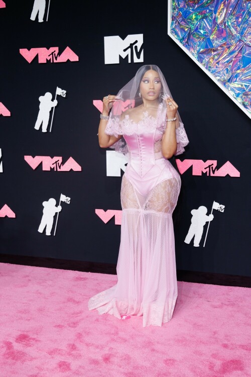 Nicki Minaj | 2023 MTV Video Music Awards in Newark, New Jersey - September 12, 2023

Nicki Minaj Is a Bridal Barbie at the 2023 MTV VMAs

She channeled romance while returning to host this year’s show

Nicki Minaj returned to her Barbiecore roots at the 2023 MTV Video Music Awards.

The rapper—who dubbed herself “Barbie” long before the doll took over the globe this year—made a grand appearance on this year’s red carpet at the Prudential Center in Newark, New Jersey. The star put her own romantic spin on lingerie dressing in a pale pink gown by Dolce & Gabbana, which featured a strapless satin bodysuit and a sheer lace mermaid skirt that fanned out into a circular train. A matching see-through veil with lace trim completed the look.

The rapper finished the monochromatic ensemble with floral-shaped earrings, a diamond tennis bracelet, and an array of diamond rings. Her opulent glam look included a sparkling eye look with pink shadow and sharp cat-eye liner, as well as a nude lip and extra-long bejeweled pink nails.

Minaj is up for six awards tonight, including Artist of the Year and Video of the Year. The host is also set to take the stage twice to perform, both as a solo act and as part of the night’s tribute to hip-hop’s 50th anniversary. For the latter, she will join Lil Wayne, Darryl “DMC” McDaniels, Doug E. Fresh, Grandmaster Flash and the Furious Five, and LL Cool J.

At last year’s awards, Minaj received the Video Vanguard Award and treated the audience to a mash-up performance of hits including “Monster,” “Moment 4 Life,” and “Anaconda.” She transformed the VMAs stage into a Barbie DreamHouse in a tribute to her fans, the Barbz, complete with a matching Barbiecore look composed of a bedazzled corset with crystal-covered sleeves, a flared light-pink skirt, and black platform boots with hot-pink laces.

harpersbazaar

#NickiMinaj #vmas