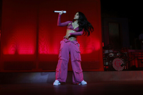 Becky G: Mi Casa, Tu Casa US Tour at the United Palace in New York, NY - September 15, 2023

‘Bienvenidos to the Mi Casa, Tu Casa Tour’: 5 Highlights From Becky G’s New York Show
Amid tears, laughs, and tequila shots, the Mexican-American singer celebrates biculturalism at NYC's United Palace.

Amid Mexican Independence Day celebrations and Hispanic Heritage Month, Becky G lit up the United Palace in Washington Heights, N.Y., on Saturday (Sept. 16).

It was her second of two nights at the 3,330-capacity venue as part of the artist’s first headlining national tour, Mi Casa, Tu Casa, which launched Sept. 14 in Boston. Upcoming dates include Atlanta (Sept. 21), Hollywood (Sept. 23), El Paso (Oct. 3), and concludes in Phoenix (Oct. 14).

“Mi nombre es Becky G y bienvenidos to the Mi Casa, Tu Casa tour,” she said in Spanglish. “New York, I’m not even going to sugar coat it, okay? Soy muy dulce a veces, pero otras veces un poquito picosa (“I’m sweet, at times, but other times, I’m a little spicy”), she said shortly after opening her show with her hit song “Mayores,” which features Bad Bunny.

Donning baggy Mexican pink cargo pants, with a long silver chain, a matching sparkly bikini top and a cowboy hat, the Inglewood native’s alluring performance included an invigorating live band, a crew of dancers, an exciting DJ set and beautiful home videos of the artist (born Rebbecca Marie Gomez) played on the screen behind the stage.

“There was so much inspiration of the 200% for me — I knew that I wanted to make a statement representing two cultures, two flags, two languages,” Becky G told Billboard Español in August in preparation for her tour. “From the color scheme to the way that we played out the setlist, and having the whole middle set of the show be dedicated to música regional was the essence of the tour. We are bringing Casa Gomez to everybody on Mi Casa, Tu Casa and it’s going to be really awesome.”

And Becky G truly delivered — her charming stage presence, her combination of “sweet and spicy” energy, her vulnerability, her connection with her fans, and deep appreciation for her foundations made this entire night very special one.

Here are five highlights from Becky G’s first headlining tour at United Palace in the Heights on Sept. 16.

Her Genre Versatility

Seamlessly spanning through reggaetón, merengue, and regional Mexican music, Becky G’s musical versatility took a spotlight. She opened up with her early breakout hit “Mayores,” a pop-reggaetón number with cumbia undertones. But one of the biggest highlights was when she segued into the música mexicana segment midway through her set, delivering corridos songs like “Chanel,” which stars Peso Pluma, “La Nena,” featuring Gabito Ballesteros, and her recent heart-rending single “Querido Abuelo,” as well as unreleased songs from her upcoming album, Esquinas. During this segment, she was backed by. a full música mexicana ensemble, consisting of trumpets, a tololoche, guitars, and a requinto. A costume change later, Becky arrived belting out the merengue song of “Arranca.”

A Proud 200 Percenter

As a proud 200 percenter, she embraced her Mexican heritage throughout, while never forgetting her American foundations with what kicked her off to stardom, a rap career with 2013’s “Becky from the Block.” But the night was extra special as we celebrated Mexican Independence Day on Sept. 16.

“Of course, I’d be crazy not to acknowledge that today and yesterday we are celebrating something very important. If you are Mexican, you already know,” she said in Spanglish, and Mexican flags lofted high. “I want to hear that grito mexicano!,” she shouted, and she wrapped around a Mexican flag she borrowed from a concert-goer.

Her Genre Versatility

Seamlessly spanning through reggaetón, merengue, and regional Mexican music, Becky G’s musical versatility took a spotlight. She opened up with her early breakout hit “Mayores,” a pop-reggaetón number with cumbia undertones. But one of the biggest highlights was when she segued into the música mexicana segment midway through her set, delivering corridos songs like “Chanel,” which stars Peso Pluma, “La Nena,” featuring Gabito Ballesteros, and her recent heart-rending single “Querido Abuelo,” as well as unreleased songs from her upcoming album, Esquinas. During this segment, she was backed by. a full música mexicana ensemble, consisting of trumpets, a tololoche, guitars, and a requinto. A costume change later, Becky arrived belting out the merengue song of “Arranca.”

A Proud 200 Percenter

As a proud 200 percenter, she embraced her Mexican heritage throughout, while never forgetting her American foundations with what kicked her off to stardom, a rap career with 2013’s “Becky from the Block.” But the night was extra special as we celebrated Mexican Independence Day on Sept. 16.

“Of course, I’d be crazy not to acknowledge that today and yesterday we are celebrating something very important. If you are Mexican, you already know,” she said in Spanglish, and Mexican flags lofted high. “I want to hear that grito mexicano!,” she shouted, and she wrapped around a Mexican flag she borrowed from a concert-goer.

Family Tribute

As soon as she completed some corridos to the delight of those in attendance, she also included a heartfelt tribute to her late grandfather, who immigrated from Mexico to Southern California to provide his family a better life. And there was a lot of emotion in the crowd. The audience began to chant “Becky, Becky” in unison, which turned on the waterworks for the performer. “I love you too,” she said shakily. “So now I’m crying and I don’t know how to stop!” she added before sharing encouraging words about how to celebrate a loved one’s life after their passing, like in the case of her grandfather, who she sang a song to called “Querido Abuelo.” Meanwhile, home videos of young Becky displayed as a backdrop singing with her cowboy hat-donning grandfather.

Selena Medley!

The Cali performer has long embraced her fandom for the Queen of Tejano Music. Fun fact: Becky G even impersonated the late, great Selena when she was just 10 years old in Sábado Gigante, and headlined the Selena Quintanilla Music Festival five years ago. On Sept. 16, the star shined bright, as she belted out the emotional lyric of “Como La Flor,” with utter respect and immense talent. Becky G and her backup band also performed “Bidi Bidi Bom Bom,” “La Carcacha,” and “Baila Esta Cumbia,” and it was magnificent.

Her Genre Versatility

Seamlessly spanning through reggaetón, merengue, and regional Mexican music, Becky G’s musical versatility took a spotlight. She opened up with her early breakout hit “Mayores,” a pop-reggaetón number with cumbia undertones. But one of the biggest highlights was when she segued into the música mexicana segment midway through her set, delivering corridos songs like “Chanel,” which stars Peso Pluma, “La Nena,” featuring Gabito Ballesteros, and her recent heart-rending single “Querido Abuelo,” as well as unreleased songs from her upcoming album, Esquinas. During this segment, she was backed by. a full música mexicana ensemble, consisting of trumpets, a tololoche, guitars, and a requinto. A costume change later, Becky arrived belting out the merengue song of “Arranca.”

A Proud 200 Percenter

As a proud 200 percenter, she embraced her Mexican heritage throughout, while never forgetting her American foundations with what kicked her off to stardom, a rap career with 2013’s “Becky from the Block.” But the night was extra special as we celebrated Mexican Independence Day on Sept. 16.

“Of course, I’d be crazy not to acknowledge that today and yesterday we are celebrating something very important. If you are Mexican, you already know,” she said in Spanglish, and Mexican flags lofted high. “I want to hear that grito mexicano!,” she shouted, and she wrapped around a Mexican flag she borrowed from a concert-goer.

Family Tribute

As soon as she completed some corridos to the delight of those in attendance, she also included a heartfelt tribute to her late grandfather, who immigrated from Mexico to Southern California to provide his family a better life. And there was a lot of emotion in the crowd. The audience began to chant “Becky, Becky” in unison, which turned on the waterworks for the performer. “I love you too,” she said shakily. “So now I’m crying and I don’t know how to stop!” she added before sharing encouraging words about how to celebrate a loved one’s life after their passing, like in the case of her grandfather, who she sang a song to called “Querido Abuelo.” Meanwhile, home videos of young Becky displayed as a backdrop singing with her cowboy hat-donning grandfather.

Selena Medley!

The Cali performer has long embraced her fandom for the Queen of Tejano Music. Fun fact: Becky G even impersonated the late, great Selena when she was just 10 years old in Sábado Gigante, and headlined the Selena Quintanilla Music Festival five years ago. On Sept. 16, the star shined bright, as she belted out the emotional lyric of “Como La Flor,” with utter respect and immense talent. Becky G and her backup band also performed “Bidi Bidi Bom Bom,” “La Carcacha,” and “Baila Esta Cumbia,” and it was magnificent.

Fan Engagement

There were plenty of emotional highs and lows when it came to the performer conveying her deep appreciation to her fans. She spoke to plenty of attendees, thoughtfully read the signs they crafted for her, and even invited a 13-year-old girl to the stage to share some dance moves, who said on stage she dreams of becoming a professional dancer.

“I don’t know if you guys know this, but I made a mailbox for this tour so you guys can leave me letters. But I really wanted to feel closer to you guys,” she said at one point.

In another moment, she reads a sign that says: “Shout out José’s birthday.” “That’s you right there with the brown jacket? Oh, there might be a lot of them [José’s], actually,” she said as the crowd chuckled. Becky proceeded to sing this mysterious José “Happy Birthday.” “Do you know what we do on our birthday?” she said. “It’s shot time … We’re taking a shot girlfriend, you better come over here,” she told a fan who’s wearing Treslúce merch, Becky G’s brand. “This one’s for you. Pa’ arriba, pa’ abajo, pa’l centro y pa’ dentro!”

billboard

#BeckyG