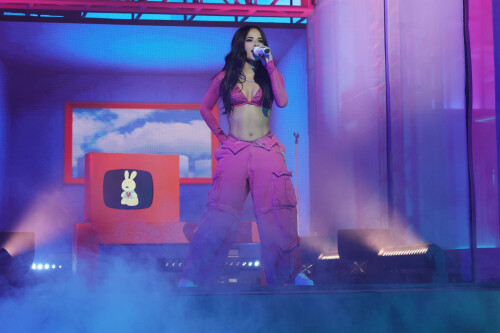 Becky G: Mi Casa, Tu Casa US Tour at the United Palace in New York, NY - September 15, 2023

‘Bienvenidos to the Mi Casa, Tu Casa Tour’: 5 Highlights From Becky G’s New York Show
Amid tears, laughs, and tequila shots, the Mexican-American singer celebrates biculturalism at NYC's United Palace.

Amid Mexican Independence Day celebrations and Hispanic Heritage Month, Becky G lit up the United Palace in Washington Heights, N.Y., on Saturday (Sept. 16).

It was her second of two nights at the 3,330-capacity venue as part of the artist’s first headlining national tour, Mi Casa, Tu Casa, which launched Sept. 14 in Boston. Upcoming dates include Atlanta (Sept. 21), Hollywood (Sept. 23), El Paso (Oct. 3), and concludes in Phoenix (Oct. 14).

“Mi nombre es Becky G y bienvenidos to the Mi Casa, Tu Casa tour,” she said in Spanglish. “New York, I’m not even going to sugar coat it, okay? Soy muy dulce a veces, pero otras veces un poquito picosa (“I’m sweet, at times, but other times, I’m a little spicy”), she said shortly after opening her show with her hit song “Mayores,” which features Bad Bunny.

Donning baggy Mexican pink cargo pants, with a long silver chain, a matching sparkly bikini top and a cowboy hat, the Inglewood native’s alluring performance included an invigorating live band, a crew of dancers, an exciting DJ set and beautiful home videos of the artist (born Rebbecca Marie Gomez) played on the screen behind the stage.

“There was so much inspiration of the 200% for me — I knew that I wanted to make a statement representing two cultures, two flags, two languages,” Becky G told Billboard Español in August in preparation for her tour. “From the color scheme to the way that we played out the setlist, and having the whole middle set of the show be dedicated to música regional was the essence of the tour. We are bringing Casa Gomez to everybody on Mi Casa, Tu Casa and it’s going to be really awesome.”

And Becky G truly delivered — her charming stage presence, her combination of “sweet and spicy” energy, her vulnerability, her connection with her fans, and deep appreciation for her foundations made this entire night very special one.

Here are five highlights from Becky G’s first headlining tour at United Palace in the Heights on Sept. 16.

Her Genre Versatility

Seamlessly spanning through reggaetón, merengue, and regional Mexican music, Becky G’s musical versatility took a spotlight. She opened up with her early breakout hit “Mayores,” a pop-reggaetón number with cumbia undertones. But one of the biggest highlights was when she segued into the música mexicana segment midway through her set, delivering corridos songs like “Chanel,” which stars Peso Pluma, “La Nena,” featuring Gabito Ballesteros, and her recent heart-rending single “Querido Abuelo,” as well as unreleased songs from her upcoming album, Esquinas. During this segment, she was backed by. a full música mexicana ensemble, consisting of trumpets, a tololoche, guitars, and a requinto. A costume change later, Becky arrived belting out the merengue song of “Arranca.”

A Proud 200 Percenter

As a proud 200 percenter, she embraced her Mexican heritage throughout, while never forgetting her American foundations with what kicked her off to stardom, a rap career with 2013’s “Becky from the Block.” But the night was extra special as we celebrated Mexican Independence Day on Sept. 16.

“Of course, I’d be crazy not to acknowledge that today and yesterday we are celebrating something very important. If you are Mexican, you already know,” she said in Spanglish, and Mexican flags lofted high. “I want to hear that grito mexicano!,” she shouted, and she wrapped around a Mexican flag she borrowed from a concert-goer.

Her Genre Versatility

Seamlessly spanning through reggaetón, merengue, and regional Mexican music, Becky G’s musical versatility took a spotlight. She opened up with her early breakout hit “Mayores,” a pop-reggaetón number with cumbia undertones. But one of the biggest highlights was when she segued into the música mexicana segment midway through her set, delivering corridos songs like “Chanel,” which stars Peso Pluma, “La Nena,” featuring Gabito Ballesteros, and her recent heart-rending single “Querido Abuelo,” as well as unreleased songs from her upcoming album, Esquinas. During this segment, she was backed by. a full música mexicana ensemble, consisting of trumpets, a tololoche, guitars, and a requinto. A costume change later, Becky arrived belting out the merengue song of “Arranca.”

A Proud 200 Percenter

As a proud 200 percenter, she embraced her Mexican heritage throughout, while never forgetting her American foundations with what kicked her off to stardom, a rap career with 2013’s “Becky from the Block.” But the night was extra special as we celebrated Mexican Independence Day on Sept. 16.

“Of course, I’d be crazy not to acknowledge that today and yesterday we are celebrating something very important. If you are Mexican, you already know,” she said in Spanglish, and Mexican flags lofted high. “I want to hear that grito mexicano!,” she shouted, and she wrapped around a Mexican flag she borrowed from a concert-goer.

Family Tribute

As soon as she completed some corridos to the delight of those in attendance, she also included a heartfelt tribute to her late grandfather, who immigrated from Mexico to Southern California to provide his family a better life. And there was a lot of emotion in the crowd. The audience began to chant “Becky, Becky” in unison, which turned on the waterworks for the performer. “I love you too,” she said shakily. “So now I’m crying and I don’t know how to stop!” she added before sharing encouraging words about how to celebrate a loved one’s life after their passing, like in the case of her grandfather, who she sang a song to called “Querido Abuelo.” Meanwhile, home videos of young Becky displayed as a backdrop singing with her cowboy hat-donning grandfather.

Selena Medley!

The Cali performer has long embraced her fandom for the Queen of Tejano Music. Fun fact: Becky G even impersonated the late, great Selena when she was just 10 years old in Sábado Gigante, and headlined the Selena Quintanilla Music Festival five years ago. On Sept. 16, the star shined bright, as she belted out the emotional lyric of “Como La Flor,” with utter respect and immense talent. Becky G and her backup band also performed “Bidi Bidi Bom Bom,” “La Carcacha,” and “Baila Esta Cumbia,” and it was magnificent.

Her Genre Versatility

Seamlessly spanning through reggaetón, merengue, and regional Mexican music, Becky G’s musical versatility took a spotlight. She opened up with her early breakout hit “Mayores,” a pop-reggaetón number with cumbia undertones. But one of the biggest highlights was when she segued into the música mexicana segment midway through her set, delivering corridos songs like “Chanel,” which stars Peso Pluma, “La Nena,” featuring Gabito Ballesteros, and her recent heart-rending single “Querido Abuelo,” as well as unreleased songs from her upcoming album, Esquinas. During this segment, she was backed by. a full música mexicana ensemble, consisting of trumpets, a tololoche, guitars, and a requinto. A costume change later, Becky arrived belting out the merengue song of “Arranca.”

A Proud 200 Percenter

As a proud 200 percenter, she embraced her Mexican heritage throughout, while never forgetting her American foundations with what kicked her off to stardom, a rap career with 2013’s “Becky from the Block.” But the night was extra special as we celebrated Mexican Independence Day on Sept. 16.

“Of course, I’d be crazy not to acknowledge that today and yesterday we are celebrating something very important. If you are Mexican, you already know,” she said in Spanglish, and Mexican flags lofted high. “I want to hear that grito mexicano!,” she shouted, and she wrapped around a Mexican flag she borrowed from a concert-goer.

Family Tribute

As soon as she completed some corridos to the delight of those in attendance, she also included a heartfelt tribute to her late grandfather, who immigrated from Mexico to Southern California to provide his family a better life. And there was a lot of emotion in the crowd. The audience began to chant “Becky, Becky” in unison, which turned on the waterworks for the performer. “I love you too,” she said shakily. “So now I’m crying and I don’t know how to stop!” she added before sharing encouraging words about how to celebrate a loved one’s life after their passing, like in the case of her grandfather, who she sang a song to called “Querido Abuelo.” Meanwhile, home videos of young Becky displayed as a backdrop singing with her cowboy hat-donning grandfather.

Selena Medley!

The Cali performer has long embraced her fandom for the Queen of Tejano Music. Fun fact: Becky G even impersonated the late, great Selena when she was just 10 years old in Sábado Gigante, and headlined the Selena Quintanilla Music Festival five years ago. On Sept. 16, the star shined bright, as she belted out the emotional lyric of “Como La Flor,” with utter respect and immense talent. Becky G and her backup band also performed “Bidi Bidi Bom Bom,” “La Carcacha,” and “Baila Esta Cumbia,” and it was magnificent.

Fan Engagement

There were plenty of emotional highs and lows when it came to the performer conveying her deep appreciation to her fans. She spoke to plenty of attendees, thoughtfully read the signs they crafted for her, and even invited a 13-year-old girl to the stage to share some dance moves, who said on stage she dreams of becoming a professional dancer.

“I don’t know if you guys know this, but I made a mailbox for this tour so you guys can leave me letters. But I really wanted to feel closer to you guys,” she said at one point.

In another moment, she reads a sign that says: “Shout out José’s birthday.” “That’s you right there with the brown jacket? Oh, there might be a lot of them [José’s], actually,” she said as the crowd chuckled. Becky proceeded to sing this mysterious José “Happy Birthday.” “Do you know what we do on our birthday?” she said. “It’s shot time … We’re taking a shot girlfriend, you better come over here,” she told a fan who’s wearing Treslúce merch, Becky G’s brand. “This one’s for you. Pa’ arriba, pa’ abajo, pa’l centro y pa’ dentro!”

billboard

#BeckyG