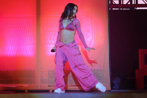 Becky G: Mi Casa, Tu Casa US Tour at the United Palace in New York, NY - September 15, 2023

‘Bienvenidos to the Mi Casa, Tu Casa Tour’: 5 Highlights From Becky G’s New York Show
Amid tears, laughs, and tequila shots, the Mexican-American singer celebrates biculturalism at NYC's United Palace.

Amid Mexican Independence Day celebrations and Hispanic Heritage Month, Becky G lit up the United Palace in Washington Heights, N.Y., on Saturday (Sept. 16).

It was her second of two nights at the 3,330-capacity venue as part of the artist’s first headlining national tour, Mi Casa, Tu Casa, which launched Sept. 14 in Boston. Upcoming dates include Atlanta (Sept. 21), Hollywood (Sept. 23), El Paso (Oct. 3), and concludes in Phoenix (Oct. 14).

“Mi nombre es Becky G y bienvenidos to the Mi Casa, Tu Casa tour,” she said in Spanglish. “New York, I’m not even going to sugar coat it, okay? Soy muy dulce a veces, pero otras veces un poquito picosa (“I’m sweet, at times, but other times, I’m a little spicy”), she said shortly after opening her show with her hit song “Mayores,” which features Bad Bunny.

Donning baggy Mexican pink cargo pants, with a long silver chain, a matching sparkly bikini top and a cowboy hat, the Inglewood native’s alluring performance included an invigorating live band, a crew of dancers, an exciting DJ set and beautiful home videos of the artist (born Rebbecca Marie Gomez) played on the screen behind the stage.

“There was so much inspiration of the 200% for me — I knew that I wanted to make a statement representing two cultures, two flags, two languages,” Becky G told Billboard Español in August in preparation for her tour. “From the color scheme to the way that we played out the setlist, and having the whole middle set of the show be dedicated to música regional was the essence of the tour. We are bringing Casa Gomez to everybody on Mi Casa, Tu Casa and it’s going to be really awesome.”

And Becky G truly delivered — her charming stage presence, her combination of “sweet and spicy” energy, her vulnerability, her connection with her fans, and deep appreciation for her foundations made this entire night very special one.

Here are five highlights from Becky G’s first headlining tour at United Palace in the Heights on Sept. 16.

Her Genre Versatility

Seamlessly spanning through reggaetón, merengue, and regional Mexican music, Becky G’s musical versatility took a spotlight. She opened up with her early breakout hit “Mayores,” a pop-reggaetón number with cumbia undertones. But one of the biggest highlights was when she segued into the música mexicana segment midway through her set, delivering corridos songs like “Chanel,” which stars Peso Pluma, “La Nena,” featuring Gabito Ballesteros, and her recent heart-rending single “Querido Abuelo,” as well as unreleased songs from her upcoming album, Esquinas. During this segment, she was backed by. a full música mexicana ensemble, consisting of trumpets, a tololoche, guitars, and a requinto. A costume change later, Becky arrived belting out the merengue song of “Arranca.”

A Proud 200 Percenter

As a proud 200 percenter, she embraced her Mexican heritage throughout, while never forgetting her American foundations with what kicked her off to stardom, a rap career with 2013’s “Becky from the Block.” But the night was extra special as we celebrated Mexican Independence Day on Sept. 16.

“Of course, I’d be crazy not to acknowledge that today and yesterday we are celebrating something very important. If you are Mexican, you already know,” she said in Spanglish, and Mexican flags lofted high. “I want to hear that grito mexicano!,” she shouted, and she wrapped around a Mexican flag she borrowed from a concert-goer.

Her Genre Versatility

Seamlessly spanning through reggaetón, merengue, and regional Mexican music, Becky G’s musical versatility took a spotlight. She opened up with her early breakout hit “Mayores,” a pop-reggaetón number with cumbia undertones. But one of the biggest highlights was when she segued into the música mexicana segment midway through her set, delivering corridos songs like “Chanel,” which stars Peso Pluma, “La Nena,” featuring Gabito Ballesteros, and her recent heart-rending single “Querido Abuelo,” as well as unreleased songs from her upcoming album, Esquinas. During this segment, she was backed by. a full música mexicana ensemble, consisting of trumpets, a tololoche, guitars, and a requinto. A costume change later, Becky arrived belting out the merengue song of “Arranca.”

A Proud 200 Percenter

As a proud 200 percenter, she embraced her Mexican heritage throughout, while never forgetting her American foundations with what kicked her off to stardom, a rap career with 2013’s “Becky from the Block.” But the night was extra special as we celebrated Mexican Independence Day on Sept. 16.

“Of course, I’d be crazy not to acknowledge that today and yesterday we are celebrating something very important. If you are Mexican, you already know,” she said in Spanglish, and Mexican flags lofted high. “I want to hear that grito mexicano!,” she shouted, and she wrapped around a Mexican flag she borrowed from a concert-goer.

Family Tribute

As soon as she completed some corridos to the delight of those in attendance, she also included a heartfelt tribute to her late grandfather, who immigrated from Mexico to Southern California to provide his family a better life. And there was a lot of emotion in the crowd. The audience began to chant “Becky, Becky” in unison, which turned on the waterworks for the performer. “I love you too,” she said shakily. “So now I’m crying and I don’t know how to stop!” she added before sharing encouraging words about how to celebrate a loved one’s life after their passing, like in the case of her grandfather, who she sang a song to called “Querido Abuelo.” Meanwhile, home videos of young Becky displayed as a backdrop singing with her cowboy hat-donning grandfather.

Selena Medley!

The Cali performer has long embraced her fandom for the Queen of Tejano Music. Fun fact: Becky G even impersonated the late, great Selena when she was just 10 years old in Sábado Gigante, and headlined the Selena Quintanilla Music Festival five years ago. On Sept. 16, the star shined bright, as she belted out the emotional lyric of “Como La Flor,” with utter respect and immense talent. Becky G and her backup band also performed “Bidi Bidi Bom Bom,” “La Carcacha,” and “Baila Esta Cumbia,” and it was magnificent.

Her Genre Versatility

Seamlessly spanning through reggaetón, merengue, and regional Mexican music, Becky G’s musical versatility took a spotlight. She opened up with her early breakout hit “Mayores,” a pop-reggaetón number with cumbia undertones. But one of the biggest highlights was when she segued into the música mexicana segment midway through her set, delivering corridos songs like “Chanel,” which stars Peso Pluma, “La Nena,” featuring Gabito Ballesteros, and her recent heart-rending single “Querido Abuelo,” as well as unreleased songs from her upcoming album, Esquinas. During this segment, she was backed by. a full música mexicana ensemble, consisting of trumpets, a tololoche, guitars, and a requinto. A costume change later, Becky arrived belting out the merengue song of “Arranca.”

A Proud 200 Percenter

As a proud 200 percenter, she embraced her Mexican heritage throughout, while never forgetting her American foundations with what kicked her off to stardom, a rap career with 2013’s “Becky from the Block.” But the night was extra special as we celebrated Mexican Independence Day on Sept. 16.

“Of course, I’d be crazy not to acknowledge that today and yesterday we are celebrating something very important. If you are Mexican, you already know,” she said in Spanglish, and Mexican flags lofted high. “I want to hear that grito mexicano!,” she shouted, and she wrapped around a Mexican flag she borrowed from a concert-goer.

Family Tribute

As soon as she completed some corridos to the delight of those in attendance, she also included a heartfelt tribute to her late grandfather, who immigrated from Mexico to Southern California to provide his family a better life. And there was a lot of emotion in the crowd. The audience began to chant “Becky, Becky” in unison, which turned on the waterworks for the performer. “I love you too,” she said shakily. “So now I’m crying and I don’t know how to stop!” she added before sharing encouraging words about how to celebrate a loved one’s life after their passing, like in the case of her grandfather, who she sang a song to called “Querido Abuelo.” Meanwhile, home videos of young Becky displayed as a backdrop singing with her cowboy hat-donning grandfather.

Selena Medley!

The Cali performer has long embraced her fandom for the Queen of Tejano Music. Fun fact: Becky G even impersonated the late, great Selena when she was just 10 years old in Sábado Gigante, and headlined the Selena Quintanilla Music Festival five years ago. On Sept. 16, the star shined bright, as she belted out the emotional lyric of “Como La Flor,” with utter respect and immense talent. Becky G and her backup band also performed “Bidi Bidi Bom Bom,” “La Carcacha,” and “Baila Esta Cumbia,” and it was magnificent.

Fan Engagement

There were plenty of emotional highs and lows when it came to the performer conveying her deep appreciation to her fans. She spoke to plenty of attendees, thoughtfully read the signs they crafted for her, and even invited a 13-year-old girl to the stage to share some dance moves, who said on stage she dreams of becoming a professional dancer.

“I don’t know if you guys know this, but I made a mailbox for this tour so you guys can leave me letters. But I really wanted to feel closer to you guys,” she said at one point.

In another moment, she reads a sign that says: “Shout out José’s birthday.” “That’s you right there with the brown jacket? Oh, there might be a lot of them [José’s], actually,” she said as the crowd chuckled. Becky proceeded to sing this mysterious José “Happy Birthday.” “Do you know what we do on our birthday?” she said. “It’s shot time … We’re taking a shot girlfriend, you better come over here,” she told a fan who’s wearing Treslúce merch, Becky G’s brand. “This one’s for you. Pa’ arriba, pa’ abajo, pa’l centro y pa’ dentro!”

billboard

#BeckyG