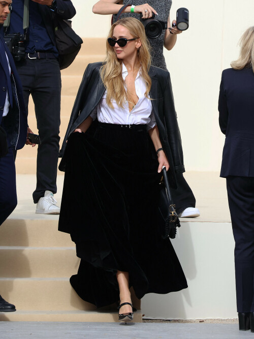 Jennifer Lawrence | Dior Fashion Show In Paris, France - September 26, 2023

Jennifer Lawrence Makes Timeless Statement in Classic Black Pumps at Dior’s Spring 2024 Paris Fashion Week Show



Jennifer Lawrence has a long-standing relationship with Dior, so it didn’t come as much of a surprise to see her hit the front row to take in the brand’s latest womenswear collection at Paris Fashion Week on Tuesday.

The Oscar-winning actress looked sophisticated in a sleek, black-and-white outfit as she joined other brand ambassadors, including Charlize Theron, Anya Taylor-Joy and Robert Pattinson, for a photocall ahead of the show.

Lawrence’s elegant look was complete with timeless black pumps, a velvety style with a pointed toe that just peaked out from underneath her long skirt.

On top, the “Silver Linings Playbook” star, 33, donned a classic white collared shirt with several buttons undone and the sleeves cuffed just below the elbow. She tucked the crisp shirt into a black belted velvet skirt that skimmed the tops of her stiletto-clad feet. Posing casually, she made use of the glamorous maxi skirt’s pockets.

Lawrence, who was seated next to Rosalía in the front row, accessorized her chic getup with a silver watch, chunky gold hoop earrings and dramatic cat-eye sunglasses.

Lawrence was first tapped as a muse for Dior after skyrocketing to fame in 2012 due to her starring role in the first “Hunger Games” film. The French luxury fashion house’s creative director Raf Simons said of selecting Lawrence, “I was struck by her incredible on-screen presence in these blockbuster films, but also by her powerful interpretations of subtler, more rounded characters.” In 2014, she would go on to extend her deal with the brand for another three years for $15 million.

footwearnews

#JenniferLawrence