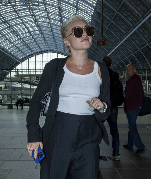 Florence Pugh arriving St Pancras Station in London, UK - October 2, 2023

Florence Pugh rocks a white vest and shades as arrive in London after Paris Fashion Week

Actress Florence, 27, went braless beneath a white top which she teamed with a pair of loose-fitting black trousers and a matching jacket.

She wore some comfortable white and grey trainers and shielded her eyes behind a pair of dark sunglasses as she made her way across the concourse at St Pancras Station after stepping off the Eurostar train.

The fashionista completed her look by wearing some white trainers for her arrival in the UK.

It comes after Florence recently defended having her nipples on show in a sheer pink gown at Valentino's haute couture show in Rome.

In an interview with ELLE, Florence shared her candid reaction to others who scrutinise her appearance.

She said: 'When everything went down with the Valentino pink dress a year ago, my nipples were on display through a piece of fabric, and it really wound people up.

'It's the freedom that people are scared of the fact I'm comfortable and happy. Keeping women down by commenting on their bodies has worked for a very long time. I think we're in this swing now where lots of people are saying, 'I don't give a s**t.'

'Unfortunately, we've become so terrified of the human body that we can't even look at my two little cute nipples behind fabric in a way that isn't sexual.

'We need to keep reminding everybody that there is more than one reason for women's bodies [to exist].'

In July last year, Florence was cruelly trolled for wearing a sheer gown at the Valentino fashion show in Rome.

At the time, she hit back at the comments she received from 'vulgar' men as well as those who chose to 'publicly destroy a woman's body' with their remarks.

She wrote in an impassioned post on Instagram: 'What's been interesting to watch and witness is just how easy it is for men to totally destroy a woman's body, publicly, proudly, for everyone to see.

'So many of you wanted to aggressively let me know how disappointed you were by my 'tiny t**s', or how I should be embarrassed by being so "flat chested". I've lived in my body for a long time. I'm fully aware of my breast size and am not scared of it.'

The Don't Worry Darling star started her post by telling fans she knew the dress would provoke a reaction, but she was 'excited' to wear the gown.

DailyMail

#FlorencePugh
