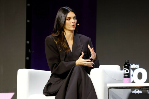Kendall Jenner | 2023 Forbes 30 Under 30 Summit, Cleveland Public Auditorium - October 9, 2023

Kendall Jenner Exudes Professionalism in a Sophisticated Black Double-Breasted Suit and Skirt at Forbes 30 Under 30 Summit 2023 in Cleveland

Kendall Jenner had business style to spare when she made an entrance at the 2023 Forbes 30 Under 30 Summit in Cleveland, Ohio.

The 27-year-old model and Kardashians fixture looked effortlessly elegant in a striking suit, though she swapped out pants in favor of a maxi skirt.

Though she wasn’t part of the main 30 Under 30 list for this year, Kendall was still an in-demand interview subject for the summit.

She spoke at the summit about how she had expanded from being a star of the catwalk to becoming an alcoholic beverage mogul with her 818 Tequila label.

The event also featured another conversation with her boyfriend, the rapper and singer Bad Bunny.

She appeared to wear the jacket without a shirt on underneath, as its plunging design showcased her bare chest.

Kendall paired the jacket, which featured a single ʙuттon in the center flanked by longer rows on the sides, with a long skirt that nearly reached to the ground.

She stayed on the monochromatic theme with a set of black leather boots that elevated her 5ft11in height.

The reality star wore her highlighted raven locks parted down the middle and styled in a long, wavy bob, which framed her earrings and impeccably made-up visage.

Joining Kendall on the red carpet was Moira Forbes, the daughter of Forbes editor-in-chief Steve Forbes and the magazine’s Executive Vice President. She has a column with the magazine and also published the quarterly ForbesWoman, which focuses on high-profile women in business and other leadership positions.

Moira highlighted her trim figure in a sleeveless black leather dress that complemented Kendall’s ensemble.

Kendall was also seen on the red carpet getting cozy with Kristin Stoller, the senior editor of Forbes 30 Under 30 lists.

The journalist contrasted her in a modest crimson dress.

During her chat on stage with Forbes, Kendall admitted that she had had doubts about trying to expand from modeling into business.

‘I’d be lying if I said I haven’t had moments of self doubt and confusion,’ she said, according to Forbes. ‘The shift into being a founder and owning my business was a really cool way of getting to know myself.’

She admitted that she — and any other business leader — would make mistakes along the way, but ‘working with integrity and authenticity is always going to create positive results.’

As an example of one of those potential missteps, Kendall recounted how she was accused of cultural appropriation when she founded the tequila label in 2021. However, she said she had taken steps to ᴀssuage those concerns by focusing on the brand’s socially conscious side goals.

One way she said 818 Tequila tries to give back is to recycle wasted agave fibers into bricks, which are then donated in Mexico to help create new structures.

s9.wiki

15 HQ pics: http://kosty555.info/index.php?showtopic=301691

#KendallJenner