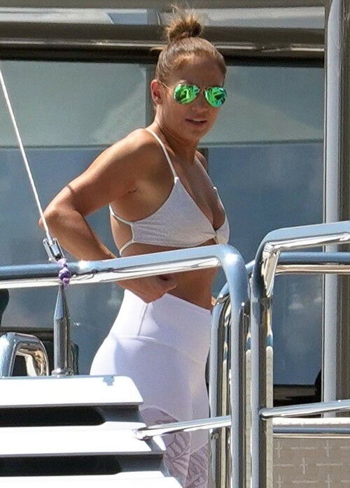 Jennifer Lopez | Workout on a yacht in Costiera Amalfitana Capri - August 7, 2018

SHIP SHAPE: Jennifer Lopez works out on the deck of a super-yacht on romantic holiday in Italy with boyfriend Alex Rodriguez

The singer/actress refused to let her holiday get in the way of her fitness regime as she cruised around the island of Capri with her man

JENNIFER Lopez looks ship shape working out on the deck of a super-yacht during a romantic holiday in Italy with her boyfriend Alex Rodriguez.

The singer/actress, 49, was pictured in a white bikini as she cruised around the island of Capri with her man.

Jennifer Lopez braved the heat by working out on the deck of a super-yacht

The couple chilled out on cushions as they soaked up the sun together on the luxury vessel during a trip down Italy's Amalfi Coast.

As well as taking in the lavish island of Capri, they also headed down to the town of Positano.

J-Lo was seen stretched out on the deck before leaning in to get close to her man.

However, the singer/actress can't sit about doing nothing for long and was later seen working out on deck despite the soaring temperatures.

Jennifer lifted weights as she kept up her gruelling fitness routine even though she's on holiday.

The couple's holiday comes just days after J-Lo sparked engagement rumours by flashing a huge diamond sparkler on her wedding ring finger.

The megastar celebrated her 49th birthday with baseball legend Alex, 42, in the Bahamas and wore the Cartier ring in holiday snaps shared on Instagram.

In one pic taken by her pal and photographer Ana Carballosa, J-Lo made no effort to hide the expensive silver ring and its unique intricate design made sure it was hard to miss.

Jen captioned her gallery of photos with a warm tribute to her family and fans - but didn't confirm if she's engaged.

She wrote: "So believe it or not I’m just waking up from my birthday celebration last night. It was a small gathering with the kids and some family and a couple of close friends...

"The day and night was filled with lots of laughter, tears and of course dancing...:) I wanted to write all of you bc I was so delighted and overwhelmed by the outpouring of love and birthday wishes you all sent to me yesterday!!

The Sun

#JenniferLopez #JLo