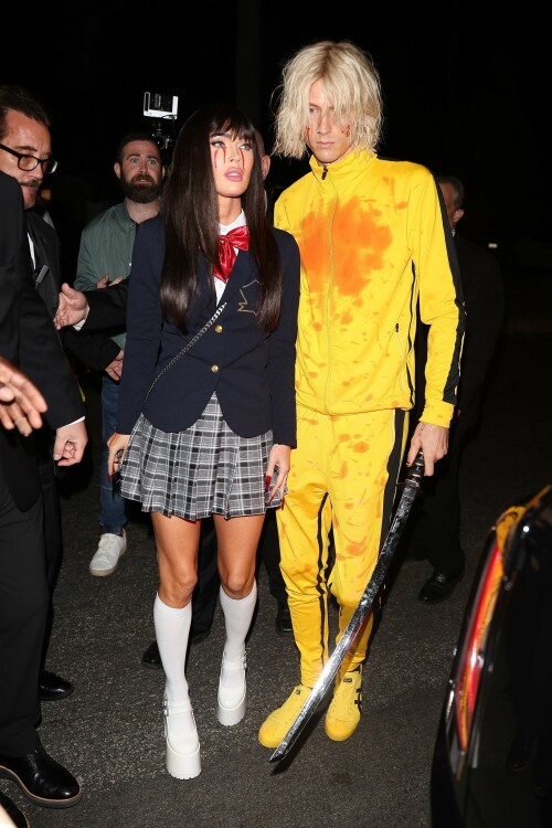 Megan Fox and Machine Gun Kelly showed their love for Quentin Tarantino's action flick Kill Bill at Casamigos Halloween party in LA - October 27, 2023

Machine Gun Kelly and Megan Fox Wear Kill Bill-Inspired Costumes for Casamigos Halloween Party in L.A.

The engaged couple celebrated the spooky holiday together after wowing in fun costumes in previous years

Megan Fox and Machine Gun Kelly have nailed Halloween, once again.

The couple was photographed coordinating Kill Bill-inspired costumes at the annual Casamigos Halloween Party in Beverly Hills on Friday night.

Each of the couple opted to dress as a character from Quentin Tarantino's 2003 movie, Kill Bill: Volume 1 and they even added a little fake blood to stay true to their characters of choice from the iconic movie.

Fox, 37, wore a costume inspired by the schoolgirl assassin Gogo Yubari, played by actress Chiaki Kuriyama in the movie. The actress teamed a black wig with a schoolgirl outfit that she wore with platform white boots and knee-length socks. In a nod to the character's rather gruesome death, which saw blood pouring from her eyes, Fox also had fake blood make-up worn down her cheeks.

Kelly meanwhile, dressed as Uma Thurman's now iconic Bride character from the movie. The musician, 33, wore the yellow jumpsuit Thurman's character sported in the film and held what appeared to be a replica of the Samurai sword wielded by her character, the Bride. The singer's outfit also featured some fake blood over his face and the chest of his jumpsuit, nodding to the various fight scenes Thurman's character took part in during Kill Bill.

During the bash, the couple was spotted hanging out together near the entrance after posing for photos, looking relaxed, smiley and friendly as they spoke with other guests.

The couple were joined at the Casamigos Tequila bash by plenty of other stars in fun costumes, including Cindy Crawford, and Randy Gerber — who hosts the annual party, which this year included a fantastical garden and Wonderland in the backyard.

Kaia Gerber and Presley Gerber also showed up at the bash, with the model accompanied by her boyfriend Austin Butler. Other stars in attendance included Justin Bieber, Paris Hilton, Alessandra Ambrosio, Sarah Hyland and Wells Adams, Glen Powell, Victoria Justice, Jason and Brett Oppenheim,Edward Norton and Jenna Dewan.

When Kelly and Fox — who got engaged in January 2022 — have stepped out in recent months, the actress has been rocking flame red hair. The short, bright tresses are a total change-up from her typical long, dark hairstyle. However her Friday night Halloween look marked a temporary return to her more familiar darker locks.

In 2022, Fox and Kelly's couple's costume was one of the most fun celebrity Halloween looks of the year. They channeled Pamela Anderson and Tommy Lee at the Casamigos Tequila Halloween party in Beverly Hills.

The pair specifically channeled the former couple's looks at the 1995 grand opening party for the Hard Rock Hotel & Casino in Las Vegas, wit Fox sizzling in a two-tone pink and red latex mini-dress with a sweetheart neckline. She topped the ensemble off with a bleached wig, big lips, long nails and a fresh tan.

MGK, meanwhile, had the Mötley Crüe drummer's look down in a white tank top showing off a sleeve of tattoos, black leather pants and a layer of black eyeliner paired with his jet-black hair.

people

#MeganFox #MachineGunKelly #Halloween