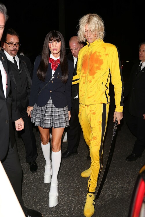 Megan Fox and Machine Gun Kelly showed their love for Quentin Tarantino's action flick Kill Bill at Casamigos Halloween party in LA - October 27, 2023

Machine Gun Kelly and Megan Fox Wear Kill Bill-Inspired Costumes for Casamigos Halloween Party in L.A.

The engaged couple celebrated the spooky holiday together after wowing in fun costumes in previous years

Megan Fox and Machine Gun Kelly have nailed Halloween, once again.

The couple was photographed coordinating Kill Bill-inspired costumes at the annual Casamigos Halloween Party in Beverly Hills on Friday night.

Each of the couple opted to dress as a character from Quentin Tarantino's 2003 movie, Kill Bill: Volume 1 and they even added a little fake blood to stay true to their characters of choice from the iconic movie.

Fox, 37, wore a costume inspired by the schoolgirl assassin Gogo Yubari, played by actress Chiaki Kuriyama in the movie. The actress teamed a black wig with a schoolgirl outfit that she wore with platform white boots and knee-length socks. In a nod to the character's rather gruesome death, which saw blood pouring from her eyes, Fox also had fake blood make-up worn down her cheeks.

Kelly meanwhile, dressed as Uma Thurman's now iconic Bride character from the movie. The musician, 33, wore the yellow jumpsuit Thurman's character sported in the film and held what appeared to be a replica of the Samurai sword wielded by her character, the Bride. The singer's outfit also featured some fake blood over his face and the chest of his jumpsuit, nodding to the various fight scenes Thurman's character took part in during Kill Bill.

During the bash, the couple was spotted hanging out together near the entrance after posing for photos, looking relaxed, smiley and friendly as they spoke with other guests.

The couple were joined at the Casamigos Tequila bash by plenty of other stars in fun costumes, including Cindy Crawford, and Randy Gerber — who hosts the annual party, which this year included a fantastical garden and Wonderland in the backyard.

Kaia Gerber and Presley Gerber also showed up at the bash, with the model accompanied by her boyfriend Austin Butler. Other stars in attendance included Justin Bieber, Paris Hilton, Alessandra Ambrosio, Sarah Hyland and Wells Adams, Glen Powell, Victoria Justice, Jason and Brett Oppenheim,Edward Norton and Jenna Dewan.

When Kelly and Fox — who got engaged in January 2022 — have stepped out in recent months, the actress has been rocking flame red hair. The short, bright tresses are a total change-up from her typical long, dark hairstyle. However her Friday night Halloween look marked a temporary return to her more familiar darker locks.

In 2022, Fox and Kelly's couple's costume was one of the most fun celebrity Halloween looks of the year. They channeled Pamela Anderson and Tommy Lee at the Casamigos Tequila Halloween party in Beverly Hills.

The pair specifically channeled the former couple's looks at the 1995 grand opening party for the Hard Rock Hotel & Casino in Las Vegas, wit Fox sizzling in a two-tone pink and red latex mini-dress with a sweetheart neckline. She topped the ensemble off with a bleached wig, big lips, long nails and a fresh tan.

MGK, meanwhile, had the Mötley Crüe drummer's look down in a white tank top showing off a sleeve of tattoos, black leather pants and a layer of black eyeliner paired with his jet-black hair.

people

#MeganFox #MachineGunKelly #Halloween