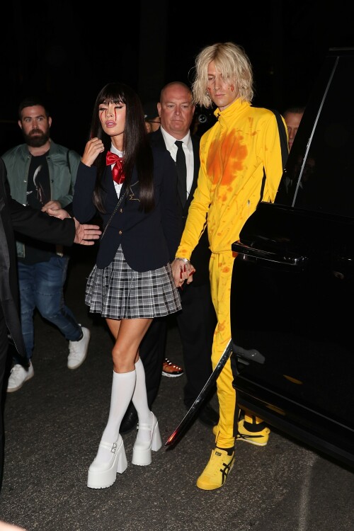 Megan Fox and Machine Gun Kelly showed their love for Quentin Tarantino's action flick Kill Bill at Casamigos Halloween party in LA - October 27, 2023

Machine Gun Kelly and Megan Fox Wear Kill Bill-Inspired Costumes for Casamigos Halloween Party in L.A.

The engaged couple celebrated the spooky holiday together after wowing in fun costumes in previous years

Megan Fox and Machine Gun Kelly have nailed Halloween, once again.

The couple was photographed coordinating Kill Bill-inspired costumes at the annual Casamigos Halloween Party in Beverly Hills on Friday night.

Each of the couple opted to dress as a character from Quentin Tarantino's 2003 movie, Kill Bill: Volume 1 and they even added a little fake blood to stay true to their characters of choice from the iconic movie.

Fox, 37, wore a costume inspired by the schoolgirl assassin Gogo Yubari, played by actress Chiaki Kuriyama in the movie. The actress teamed a black wig with a schoolgirl outfit that she wore with platform white boots and knee-length socks. In a nod to the character's rather gruesome death, which saw blood pouring from her eyes, Fox also had fake blood make-up worn down her cheeks.

Kelly meanwhile, dressed as Uma Thurman's now iconic Bride character from the movie. The musician, 33, wore the yellow jumpsuit Thurman's character sported in the film and held what appeared to be a replica of the Samurai sword wielded by her character, the Bride. The singer's outfit also featured some fake blood over his face and the chest of his jumpsuit, nodding to the various fight scenes Thurman's character took part in during Kill Bill.

During the bash, the couple was spotted hanging out together near the entrance after posing for photos, looking relaxed, smiley and friendly as they spoke with other guests.

The couple were joined at the Casamigos Tequila bash by plenty of other stars in fun costumes, including Cindy Crawford, and Randy Gerber — who hosts the annual party, which this year included a fantastical garden and Wonderland in the backyard.

Kaia Gerber and Presley Gerber also showed up at the bash, with the model accompanied by her boyfriend Austin Butler. Other stars in attendance included Justin Bieber, Paris Hilton, Alessandra Ambrosio, Sarah Hyland and Wells Adams, Glen Powell, Victoria Justice, Jason and Brett Oppenheim,Edward Norton and Jenna Dewan.

When Kelly and Fox — who got engaged in January 2022 — have stepped out in recent months, the actress has been rocking flame red hair. The short, bright tresses are a total change-up from her typical long, dark hairstyle. However her Friday night Halloween look marked a temporary return to her more familiar darker locks.

In 2022, Fox and Kelly's couple's costume was one of the most fun celebrity Halloween looks of the year. They channeled Pamela Anderson and Tommy Lee at the Casamigos Tequila Halloween party in Beverly Hills.

The pair specifically channeled the former couple's looks at the 1995 grand opening party for the Hard Rock Hotel & Casino in Las Vegas, wit Fox sizzling in a two-tone pink and red latex mini-dress with a sweetheart neckline. She topped the ensemble off with a bleached wig, big lips, long nails and a fresh tan.

MGK, meanwhile, had the Mötley Crüe drummer's look down in a white tank top showing off a sleeve of tattoos, black leather pants and a layer of black eyeliner paired with his jet-black hair.

people

#MeganFox #MachineGunKelly #Halloween