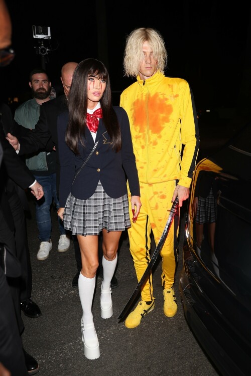 Megan Fox and Machine Gun Kelly showed their love for Quentin Tarantino's action flick Kill Bill at Casamigos Halloween party in LA - October 27, 2023

Machine Gun Kelly and Megan Fox Wear Kill Bill-Inspired Costumes for Casamigos Halloween Party in L.A.

The engaged couple celebrated the spooky holiday together after wowing in fun costumes in previous years

Megan Fox and Machine Gun Kelly have nailed Halloween, once again.

The couple was photographed coordinating Kill Bill-inspired costumes at the annual Casamigos Halloween Party in Beverly Hills on Friday night.

Each of the couple opted to dress as a character from Quentin Tarantino's 2003 movie, Kill Bill: Volume 1 and they even added a little fake blood to stay true to their characters of choice from the iconic movie.

Fox, 37, wore a costume inspired by the schoolgirl assassin Gogo Yubari, played by actress Chiaki Kuriyama in the movie. The actress teamed a black wig with a schoolgirl outfit that she wore with platform white boots and knee-length socks. In a nod to the character's rather gruesome death, which saw blood pouring from her eyes, Fox also had fake blood make-up worn down her cheeks.

Kelly meanwhile, dressed as Uma Thurman's now iconic Bride character from the movie. The musician, 33, wore the yellow jumpsuit Thurman's character sported in the film and held what appeared to be a replica of the Samurai sword wielded by her character, the Bride. The singer's outfit also featured some fake blood over his face and the chest of his jumpsuit, nodding to the various fight scenes Thurman's character took part in during Kill Bill.

During the bash, the couple was spotted hanging out together near the entrance after posing for photos, looking relaxed, smiley and friendly as they spoke with other guests.

The couple were joined at the Casamigos Tequila bash by plenty of other stars in fun costumes, including Cindy Crawford, and Randy Gerber — who hosts the annual party, which this year included a fantastical garden and Wonderland in the backyard.

Kaia Gerber and Presley Gerber also showed up at the bash, with the model accompanied by her boyfriend Austin Butler. Other stars in attendance included Justin Bieber, Paris Hilton, Alessandra Ambrosio, Sarah Hyland and Wells Adams, Glen Powell, Victoria Justice, Jason and Brett Oppenheim,Edward Norton and Jenna Dewan.

When Kelly and Fox — who got engaged in January 2022 — have stepped out in recent months, the actress has been rocking flame red hair. The short, bright tresses are a total change-up from her typical long, dark hairstyle. However her Friday night Halloween look marked a temporary return to her more familiar darker locks.

In 2022, Fox and Kelly's couple's costume was one of the most fun celebrity Halloween looks of the year. They channeled Pamela Anderson and Tommy Lee at the Casamigos Tequila Halloween party in Beverly Hills.

The pair specifically channeled the former couple's looks at the 1995 grand opening party for the Hard Rock Hotel & Casino in Las Vegas, wit Fox sizzling in a two-tone pink and red latex mini-dress with a sweetheart neckline. She topped the ensemble off with a bleached wig, big lips, long nails and a fresh tan.

MGK, meanwhile, had the Mötley Crüe drummer's look down in a white tank top showing off a sleeve of tattoos, black leather pants and a layer of black eyeliner paired with his jet-black hair.

people

#MeganFox #MachineGunKelly #Halloween