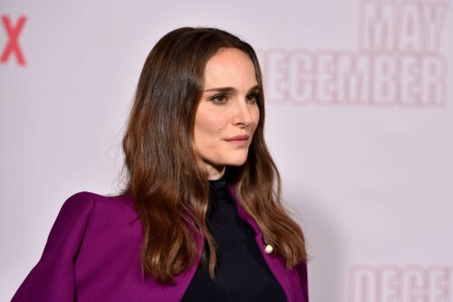 Natalie Portman | Netflix's 'May December' Photocall, Los Angeles - November 17, 2023

Natalie Portman gets leggy in sequin miniskirt and fitted black top alongside co-star Julianne Moore at photocall for new film May December in LA

Natalie Portman, Julianne Moore, and members of the cast and crew for May December are on full-on promotional mode for the new film from director Todd Haynes.

On Friday, the two A-list Oscar winners attended Netflix's Los Angeles Photo Call for the black comedy-drama that was held at the Four Seasons Hotel in Beverly Hills.

The actresses were joined by their co-star Charles Melton, along with Haynes, for the photocall, which came one day after the film's Los Angeles premiere at the Academy Museum of Motion Pictures.

For a second day in a row, Portman appeared to go solo and not wear her wedding ring on the red carpet, in the wake of cheating allegations waged against her husband Benjamin Millepied in recent months.

While she opted to keep the accessories to a minimum, Portman showed off her petite figure and fashion sense by stepping out in a sequin miniskirt that glistened under the lights of the event, and a black form-fitted top.

The miniskirt was predominantly black and silver, but the garment also had touches of purple, white and burgundy.

The Jerusalem, Israel native, who grew up in Washington, D.C., Connecticut and Long Island, New York, also wore a purple jacket over her shoulder at times during the photocall.

Rounding out her overall look, the Oscar-winning actress also donned a pair of black open-toe heels, and had her dark brown locks styled long with some natural waves and a part in the middle.

After striking a number of poses by herself, Portman was then joined on the red carpet by Moore, who was decked out in an all-black ensemble consisting of a long skirt and a matching short-sleeve top that hugged her fit figure.

She also wore a pair of black open-toe heels, and had her ginger tresses flowing long and straight a few inches down her back with a center part.

Moore, a Fort Bragg, North Carolina native who moved around the U.S. a lot as the child of a military father, would also pose for photographers by herself.

At one point, Haynes and Melton joined in on the red carpet fun, with the actor dressed in black high-water pants, a gray sweater and black combat-style boots, and the filmmaker wearing blue jeans, a black button-down shirt and matching sneakers.

In May December, Portman plays Elizabeth Berry, a famous actress preparing for a role who travels to Savannah to meet Gracie (Julianne Moore), a character loosely inspired by Mary Kay Letourneau, according to Variety. During her stay, Elizabeth develops ambivalent feelings towards Gracie and her 30-something husband Joe, with whom she started having an unlawful relationship when he was 13.

Directed by Todd Haynes from a screenplay by Samy Burch that's based on a story by Burch and Alex Mechanik, the black comedy-drama film also stars Melton, along with D. W. Moffett, Piper Curda, Elizabeth Yu, Gabriel Chung, Cory Michael Smith and Lawrence Arancio.

The previous day, both Portman and Moore attended the Los Angeles premiere of May December at the Academy Museum of Motion Pictures.

The Black Swan star donned a black strapless dress that featured a bold feather embellishment, a pair of black ankle strap heels, and her hair styled long and straight.

And like she did on Friday, Portman was again noticeably not wearing her wedding ring, amid all the talk of Millepied's affair with climate activist Camille Etienne.

Their marriage was the subject of an article in the French publication, Voici, which claimed the French dancer and choreographer, 46, had an affair with the then 25-year-old.

'It was short-lived and it is over,' a source said when the news of the cheating broke earlier this year.

The actress has been seen without her wedding ring a number of times since then, and though there were rumors of a separation, the couple has been out together as they parent their two kids over the course of the last six months.

May December, which has received praise from critics, was released in select theaters in the U.S on November 17, before it starts to stream on Netflix on December 1.

DailyMail

#NataliePortman