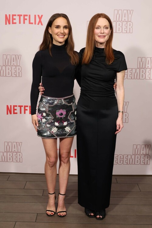 Natalie Portman | Netflix's 'May December' Photocall, Los Angeles - November 17, 2023

Natalie Portman gets leggy in sequin miniskirt and fitted black top alongside co-star Julianne Moore at photocall for new film May December in LA

Natalie Portman, Julianne Moore, and members of the cast and crew for May December are on full-on promotional mode for the new film from director Todd Haynes.

On Friday, the two A-list Oscar winners attended Netflix's Los Angeles Photo Call for the black comedy-drama that was held at the Four Seasons Hotel in Beverly Hills.

The actresses were joined by their co-star Charles Melton, along with Haynes, for the photocall, which came one day after the film's Los Angeles premiere at the Academy Museum of Motion Pictures.

For a second day in a row, Portman appeared to go solo and not wear her wedding ring on the red carpet, in the wake of cheating allegations waged against her husband Benjamin Millepied in recent months.

While she opted to keep the accessories to a minimum, Portman showed off her petite figure and fashion sense by stepping out in a sequin miniskirt that glistened under the lights of the event, and a black form-fitted top.

The miniskirt was predominantly black and silver, but the garment also had touches of purple, white and burgundy.

The Jerusalem, Israel native, who grew up in Washington, D.C., Connecticut and Long Island, New York, also wore a purple jacket over her shoulder at times during the photocall.

Rounding out her overall look, the Oscar-winning actress also donned a pair of black open-toe heels, and had her dark brown locks styled long with some natural waves and a part in the middle.

After striking a number of poses by herself, Portman was then joined on the red carpet by Moore, who was decked out in an all-black ensemble consisting of a long skirt and a matching short-sleeve top that hugged her fit figure.

She also wore a pair of black open-toe heels, and had her ginger tresses flowing long and straight a few inches down her back with a center part.

Moore, a Fort Bragg, North Carolina native who moved around the U.S. a lot as the child of a military father, would also pose for photographers by herself.

At one point, Haynes and Melton joined in on the red carpet fun, with the actor dressed in black high-water pants, a gray sweater and black combat-style boots, and the filmmaker wearing blue jeans, a black button-down shirt and matching sneakers.

In May December, Portman plays Elizabeth Berry, a famous actress preparing for a role who travels to Savannah to meet Gracie (Julianne Moore), a character loosely inspired by Mary Kay Letourneau, according to Variety. During her stay, Elizabeth develops ambivalent feelings towards Gracie and her 30-something husband Joe, with whom she started having an unlawful relationship when he was 13.

Directed by Todd Haynes from a screenplay by Samy Burch that's based on a story by Burch and Alex Mechanik, the black comedy-drama film also stars Melton, along with D. W. Moffett, Piper Curda, Elizabeth Yu, Gabriel Chung, Cory Michael Smith and Lawrence Arancio.

The previous day, both Portman and Moore attended the Los Angeles premiere of May December at the Academy Museum of Motion Pictures.

The Black Swan star donned a black strapless dress that featured a bold feather embellishment, a pair of black ankle strap heels, and her hair styled long and straight.

And like she did on Friday, Portman was again noticeably not wearing her wedding ring, amid all the talk of Millepied's affair with climate activist Camille Etienne.

Their marriage was the subject of an article in the French publication, Voici, which claimed the French dancer and choreographer, 46, had an affair with the then 25-year-old.

'It was short-lived and it is over,' a source said when the news of the cheating broke earlier this year.

The actress has been seen without her wedding ring a number of times since then, and though there were rumors of a separation, the couple has been out together as they parent their two kids over the course of the last six months.

May December, which has received praise from critics, was released in select theaters in the U.S on November 17, before it starts to stream on Netflix on December 1.

DailyMail

#NataliePortman