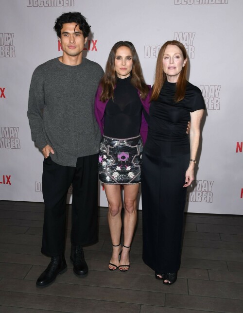 Natalie Portman | Netflix's 'May December' Photocall, Los Angeles - November 17, 2023

Natalie Portman gets leggy in sequin miniskirt and fitted black top alongside co-star Julianne Moore at photocall for new film May December in LA

Natalie Portman, Julianne Moore, and members of the cast and crew for May December are on full-on promotional mode for the new film from director Todd Haynes.

On Friday, the two A-list Oscar winners attended Netflix's Los Angeles Photo Call for the black comedy-drama that was held at the Four Seasons Hotel in Beverly Hills.

The actresses were joined by their co-star Charles Melton, along with Haynes, for the photocall, which came one day after the film's Los Angeles premiere at the Academy Museum of Motion Pictures.

For a second day in a row, Portman appeared to go solo and not wear her wedding ring on the red carpet, in the wake of cheating allegations waged against her husband Benjamin Millepied in recent months.

While she opted to keep the accessories to a minimum, Portman showed off her petite figure and fashion sense by stepping out in a sequin miniskirt that glistened under the lights of the event, and a black form-fitted top.

The miniskirt was predominantly black and silver, but the garment also had touches of purple, white and burgundy.

The Jerusalem, Israel native, who grew up in Washington, D.C., Connecticut and Long Island, New York, also wore a purple jacket over her shoulder at times during the photocall.

Rounding out her overall look, the Oscar-winning actress also donned a pair of black open-toe heels, and had her dark brown locks styled long with some natural waves and a part in the middle.

After striking a number of poses by herself, Portman was then joined on the red carpet by Moore, who was decked out in an all-black ensemble consisting of a long skirt and a matching short-sleeve top that hugged her fit figure.

She also wore a pair of black open-toe heels, and had her ginger tresses flowing long and straight a few inches down her back with a center part.

Moore, a Fort Bragg, North Carolina native who moved around the U.S. a lot as the child of a military father, would also pose for photographers by herself.

At one point, Haynes and Melton joined in on the red carpet fun, with the actor dressed in black high-water pants, a gray sweater and black combat-style boots, and the filmmaker wearing blue jeans, a black button-down shirt and matching sneakers.

In May December, Portman plays Elizabeth Berry, a famous actress preparing for a role who travels to Savannah to meet Gracie (Julianne Moore), a character loosely inspired by Mary Kay Letourneau, according to Variety. During her stay, Elizabeth develops ambivalent feelings towards Gracie and her 30-something husband Joe, with whom she started having an unlawful relationship when he was 13.

Directed by Todd Haynes from a screenplay by Samy Burch that's based on a story by Burch and Alex Mechanik, the black comedy-drama film also stars Melton, along with D. W. Moffett, Piper Curda, Elizabeth Yu, Gabriel Chung, Cory Michael Smith and Lawrence Arancio.

The previous day, both Portman and Moore attended the Los Angeles premiere of May December at the Academy Museum of Motion Pictures.

The Black Swan star donned a black strapless dress that featured a bold feather embellishment, a pair of black ankle strap heels, and her hair styled long and straight.

And like she did on Friday, Portman was again noticeably not wearing her wedding ring, amid all the talk of Millepied's affair with climate activist Camille Etienne.

Their marriage was the subject of an article in the French publication, Voici, which claimed the French dancer and choreographer, 46, had an affair with the then 25-year-old.

'It was short-lived and it is over,' a source said when the news of the cheating broke earlier this year.

The actress has been seen without her wedding ring a number of times since then, and though there were rumors of a separation, the couple has been out together as they parent their two kids over the course of the last six months.

May December, which has received praise from critics, was released in select theaters in the U.S on November 17, before it starts to stream on Netflix on December 1.

DailyMail

#NataliePortman