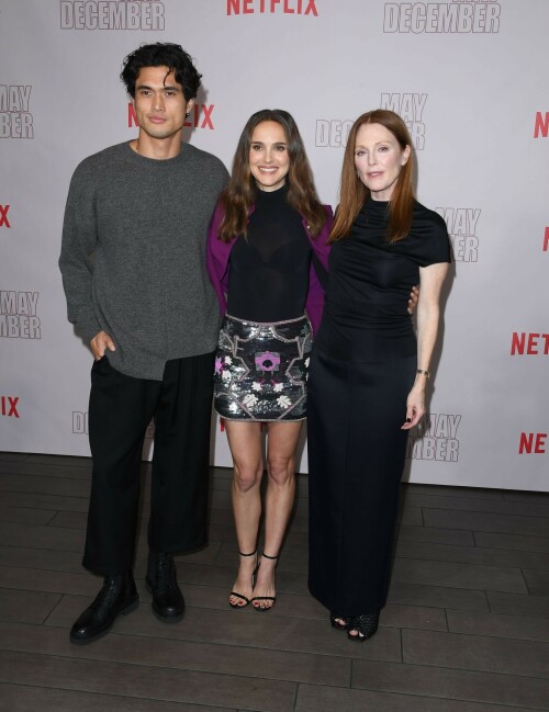 Natalie Portman | Netflix's 'May December' Photocall, Los Angeles - November 17, 2023

Natalie Portman gets leggy in sequin miniskirt and fitted black top alongside co-star Julianne Moore at photocall for new film May December in LA

Natalie Portman, Julianne Moore, and members of the cast and crew for May December are on full-on promotional mode for the new film from director Todd Haynes.

On Friday, the two A-list Oscar winners attended Netflix's Los Angeles Photo Call for the black comedy-drama that was held at the Four Seasons Hotel in Beverly Hills.

The actresses were joined by their co-star Charles Melton, along with Haynes, for the photocall, which came one day after the film's Los Angeles premiere at the Academy Museum of Motion Pictures.

For a second day in a row, Portman appeared to go solo and not wear her wedding ring on the red carpet, in the wake of cheating allegations waged against her husband Benjamin Millepied in recent months.

While she opted to keep the accessories to a minimum, Portman showed off her petite figure and fashion sense by stepping out in a sequin miniskirt that glistened under the lights of the event, and a black form-fitted top.

The miniskirt was predominantly black and silver, but the garment also had touches of purple, white and burgundy.

The Jerusalem, Israel native, who grew up in Washington, D.C., Connecticut and Long Island, New York, also wore a purple jacket over her shoulder at times during the photocall.

Rounding out her overall look, the Oscar-winning actress also donned a pair of black open-toe heels, and had her dark brown locks styled long with some natural waves and a part in the middle.

After striking a number of poses by herself, Portman was then joined on the red carpet by Moore, who was decked out in an all-black ensemble consisting of a long skirt and a matching short-sleeve top that hugged her fit figure.

She also wore a pair of black open-toe heels, and had her ginger tresses flowing long and straight a few inches down her back with a center part.

Moore, a Fort Bragg, North Carolina native who moved around the U.S. a lot as the child of a military father, would also pose for photographers by herself.

At one point, Haynes and Melton joined in on the red carpet fun, with the actor dressed in black high-water pants, a gray sweater and black combat-style boots, and the filmmaker wearing blue jeans, a black button-down shirt and matching sneakers.

In May December, Portman plays Elizabeth Berry, a famous actress preparing for a role who travels to Savannah to meet Gracie (Julianne Moore), a character loosely inspired by Mary Kay Letourneau, according to Variety. During her stay, Elizabeth develops ambivalent feelings towards Gracie and her 30-something husband Joe, with whom she started having an unlawful relationship when he was 13.

Directed by Todd Haynes from a screenplay by Samy Burch that's based on a story by Burch and Alex Mechanik, the black comedy-drama film also stars Melton, along with D. W. Moffett, Piper Curda, Elizabeth Yu, Gabriel Chung, Cory Michael Smith and Lawrence Arancio.

The previous day, both Portman and Moore attended the Los Angeles premiere of May December at the Academy Museum of Motion Pictures.

The Black Swan star donned a black strapless dress that featured a bold feather embellishment, a pair of black ankle strap heels, and her hair styled long and straight.

And like she did on Friday, Portman was again noticeably not wearing her wedding ring, amid all the talk of Millepied's affair with climate activist Camille Etienne.

Their marriage was the subject of an article in the French publication, Voici, which claimed the French dancer and choreographer, 46, had an affair with the then 25-year-old.

'It was short-lived and it is over,' a source said when the news of the cheating broke earlier this year.

The actress has been seen without her wedding ring a number of times since then, and though there were rumors of a separation, the couple has been out together as they parent their two kids over the course of the last six months.

May December, which has received praise from critics, was released in select theaters in the U.S on November 17, before it starts to stream on Netflix on December 1.

DailyMail

#NataliePortman