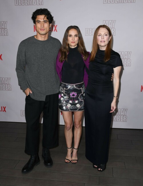 Natalie Portman | Netflix's 'May December' Photocall, Los Angeles - November 17, 2023

Natalie Portman gets leggy in sequin miniskirt and fitted black top alongside co-star Julianne Moore at photocall for new film May December in LA

Natalie Portman, Julianne Moore, and members of the cast and crew for May December are on full-on promotional mode for the new film from director Todd Haynes.

On Friday, the two A-list Oscar winners attended Netflix's Los Angeles Photo Call for the black comedy-drama that was held at the Four Seasons Hotel in Beverly Hills.

The actresses were joined by their co-star Charles Melton, along with Haynes, for the photocall, which came one day after the film's Los Angeles premiere at the Academy Museum of Motion Pictures.

For a second day in a row, Portman appeared to go solo and not wear her wedding ring on the red carpet, in the wake of cheating allegations waged against her husband Benjamin Millepied in recent months.

While she opted to keep the accessories to a minimum, Portman showed off her petite figure and fashion sense by stepping out in a sequin miniskirt that glistened under the lights of the event, and a black form-fitted top.

The miniskirt was predominantly black and silver, but the garment also had touches of purple, white and burgundy.

The Jerusalem, Israel native, who grew up in Washington, D.C., Connecticut and Long Island, New York, also wore a purple jacket over her shoulder at times during the photocall.

Rounding out her overall look, the Oscar-winning actress also donned a pair of black open-toe heels, and had her dark brown locks styled long with some natural waves and a part in the middle.

After striking a number of poses by herself, Portman was then joined on the red carpet by Moore, who was decked out in an all-black ensemble consisting of a long skirt and a matching short-sleeve top that hugged her fit figure.

She also wore a pair of black open-toe heels, and had her ginger tresses flowing long and straight a few inches down her back with a center part.

Moore, a Fort Bragg, North Carolina native who moved around the U.S. a lot as the child of a military father, would also pose for photographers by herself.

At one point, Haynes and Melton joined in on the red carpet fun, with the actor dressed in black high-water pants, a gray sweater and black combat-style boots, and the filmmaker wearing blue jeans, a black button-down shirt and matching sneakers.

In May December, Portman plays Elizabeth Berry, a famous actress preparing for a role who travels to Savannah to meet Gracie (Julianne Moore), a character loosely inspired by Mary Kay Letourneau, according to Variety. During her stay, Elizabeth develops ambivalent feelings towards Gracie and her 30-something husband Joe, with whom she started having an unlawful relationship when he was 13.

Directed by Todd Haynes from a screenplay by Samy Burch that's based on a story by Burch and Alex Mechanik, the black comedy-drama film also stars Melton, along with D. W. Moffett, Piper Curda, Elizabeth Yu, Gabriel Chung, Cory Michael Smith and Lawrence Arancio.

The previous day, both Portman and Moore attended the Los Angeles premiere of May December at the Academy Museum of Motion Pictures.

The Black Swan star donned a black strapless dress that featured a bold feather embellishment, a pair of black ankle strap heels, and her hair styled long and straight.

And like she did on Friday, Portman was again noticeably not wearing her wedding ring, amid all the talk of Millepied's affair with climate activist Camille Etienne.

Their marriage was the subject of an article in the French publication, Voici, which claimed the French dancer and choreographer, 46, had an affair with the then 25-year-old.

'It was short-lived and it is over,' a source said when the news of the cheating broke earlier this year.

The actress has been seen without her wedding ring a number of times since then, and though there were rumors of a separation, the couple has been out together as they parent their two kids over the course of the last six months.

May December, which has received praise from critics, was released in select theaters in the U.S on November 17, before it starts to stream on Netflix on December 1.

DailyMail

#NataliePortman