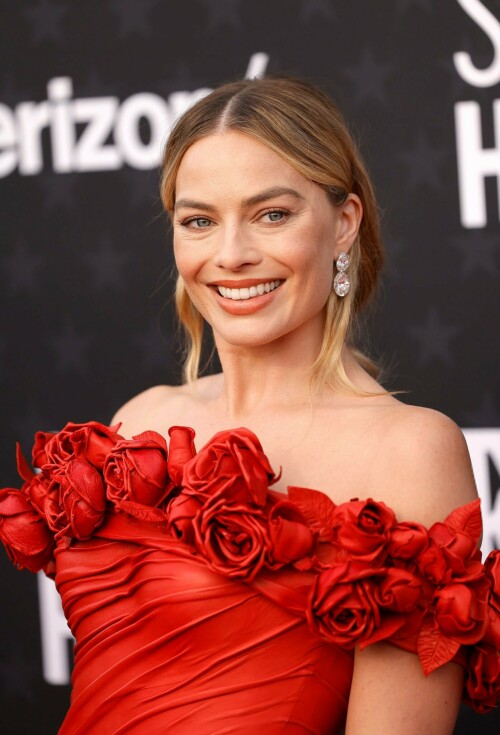 Margot Robbie | 29th Annual Critics Choice Awards in Santa Monica - 14.01.2024

Margot Robbie Brings Radiant Rose Barbie Alive in Red Balmain Dress at the Critics Choice Awards

Dua Lipa isn’t the only Barbie cast member to dress like a rose for the Critics Choice Awards. Best Actress nominee Margot Robbie attended the ceremony in her own rose-adorned look: a custom red Balmain column dress. She acessorized with Lorraine Schwartz jewelry. Her husband, Tom Ackerley, posed with her in a rare red carpet appearance for the couple. Fans speculated that she could be referencing 1996’s Radiant Rose Barbie with the outfit as the top part greatly resembles the Barbie’s red dress.

Barbie is up for 18 awards at the ceremony tonight. Robbie herself is up for Best Actress for her work in the film.

Robbie spoke to Deadline in a cover story released earlier this week about how they approached making a movie about Barbie given people’s different opinions about the doll.

She said:

We really didn’t want to avoid or appease anyone in particular. I feel that whenever characters or movies hit and feel successful, they’re holding up a mirror to the audience. Art is a way for us to understand ourselves: “By analyzing this character and their behavior, and the circumstances they’re in, I’m now able to make sense of something in my life.” That’s what I think every movie should strive to do, because you have to make it feel personal for the audience. You’ve got to make it resonate with them.

That’s not to say we all sat down trying to figure out the puzzle as you describe it. All I knew going into it was that there was an opportunity here to do that thing. It took a really smart person like Greta Gerwig to find the story, and figure out how to unpack all those things. I knew she wouldn’t be glossing over the spiky bits, which was important in our writer/director. I knew she wouldn’t be interested in doing that. She always wanted to explore both the good and the bad, because you don’t get a fully formed experience without looking at both.

But at the same time, and most important of all, it was about finding a person—and I always knew it should be Greta—who would be able to do it without mocking anything. Overall, it was important that it not be mean-spirited. It always had to come from a place of love. And I think it was about making it feel hopeful. It felt like we could hold the spiky bits and the warmth in the same hands.

At the end of the day, the movie is kind of not really about Barbie. Greta’s the genius that looked at it and went, “Aren’t humans so strange? They made a doll, then they got mad at the doll. That’s just insane.” And it’s true; we created Barbie and then we got mad at Barbie, because then we didn’t have to get mad at ourselves. We could shout at her; we could project onto her all of the perceived failings in the world, and we could direct the blame at her. It’s an inanimate object [laughs]. Isn’t that just so crazy?

I can’t claim any of these thoughts were fully fleshed out when I went after the rights for Barbie. But I knew someone would have those thoughts, and I recognized the opportunity and the kind of playground that someone smart like a Greta Gerwig could have fun in.

ELLE

#MargotRobbie