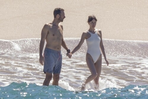 Dakota Johnson and Chris Martin Vacay In Puerto Vallarta - 20.02.2024

Dakota Johnson and Chris Martin Hold Hands on Mexico Getaway Days After Madame Web Opens

Dakota Johnson is soaking up the sun with her boyfriend Chris Martin.

The Madame Web star, 34, was seen hitting the beach in Puerto Vallarta, Mexico, with Martin, 46, on Monday. The pair were photographed holding hands as they waded into the water together, just days after Johnson's Spider-Man-related superhero movie opened in theaters on Valentine's Day.

Johnson and the Coldplay lead singer began dating in 2017, some time after Martin famously "consciously uncoupled" from his ex-wife Gwyneth Paltrow in 2014 and finalized their divorce in 2016. The couple made their first public appearance together at Stella McCartney's Autumn 2018 Collection event in January 2018.

Several years into their relationship, the couple remain private about their love life and seem to spend much of their time at their home together in Malibu, Calif. Johnson has collaborated with Martin and Coldplay as the director of the music video for their 2020 song "Cry Cry Cry," and the pair also spend time with Martin's ex Paltrow, 51, and her husband Brad Falchuk.

“We’re actually very good friends," Paltrow told her Instagram followers of her relationship with Johnson during a Q&A she conducted in October 2023. “I love her so much. She’s an adorable, wonderful person."

Johnson and Martin's Mexico vacation comes after Madame Web — which stars Johnson as a New York City paramedic who gains clairvoyant abilities — grossed $25.8 million after its opening last Wednesday, making $15.1 million between Friday and Sunday at the domestic box office and gaining an additional $25.7 million internationally.

Johnson admitted in a recent interview with MagicFM that she has not yet seen Madame Web, though she noted that she tends not to watch any of her own movies.

Dakota Johnson and Chris Martin have been dating since 2017

"For me it's a way to not have, like, an existential crisis," she said during the interview, as shared on TikTok. "Not watching my movies is self-care."
Johnson does not yet have any upcoming movies on her schedule following Madame Web. Martin, however, is scheduled to tour with Coldplay throughout this summer, beginning with the band's upcoming performances in Athens, Greece in June.

people

#DakotaJohnson #ChrisMartin