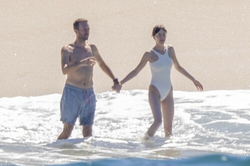 Dakota Johnson and Chris Martin Vacay In Puerto Vallarta - 20.02.2024

Dakota Johnson and Chris Martin Hold Hands on Mexico Getaway Days After Madame Web Opens

Dakota Johnson is soaking up the sun with her boyfriend Chris Martin.

The Madame Web star, 34, was seen hitting the beach in Puerto Vallarta, Mexico, with Martin, 46, on Monday. The pair were photographed holding hands as they waded into the water together, just days after Johnson's Spider-Man-related superhero movie opened in theaters on Valentine's Day.

Johnson and the Coldplay lead singer began dating in 2017, some time after Martin famously "consciously uncoupled" from his ex-wife Gwyneth Paltrow in 2014 and finalized their divorce in 2016. The couple made their first public appearance together at Stella McCartney's Autumn 2018 Collection event in January 2018.

Several years into their relationship, the couple remain private about their love life and seem to spend much of their time at their home together in Malibu, Calif. Johnson has collaborated with Martin and Coldplay as the director of the music video for their 2020 song "Cry Cry Cry," and the pair also spend time with Martin's ex Paltrow, 51, and her husband Brad Falchuk.

“We’re actually very good friends," Paltrow told her Instagram followers of her relationship with Johnson during a Q&A she conducted in October 2023. “I love her so much. She’s an adorable, wonderful person."

Johnson and Martin's Mexico vacation comes after Madame Web — which stars Johnson as a New York City paramedic who gains clairvoyant abilities — grossed $25.8 million after its opening last Wednesday, making $15.1 million between Friday and Sunday at the domestic box office and gaining an additional $25.7 million internationally.

Johnson admitted in a recent interview with MagicFM that she has not yet seen Madame Web, though she noted that she tends not to watch any of her own movies.

Dakota Johnson and Chris Martin have been dating since 2017

"For me it's a way to not have, like, an existential crisis," she said during the interview, as shared on TikTok. "Not watching my movies is self-care."
Johnson does not yet have any upcoming movies on her schedule following Madame Web. Martin, however, is scheduled to tour with Coldplay throughout this summer, beginning with the band's upcoming performances in Athens, Greece in June.

people

#DakotaJohnson #ChrisMartin