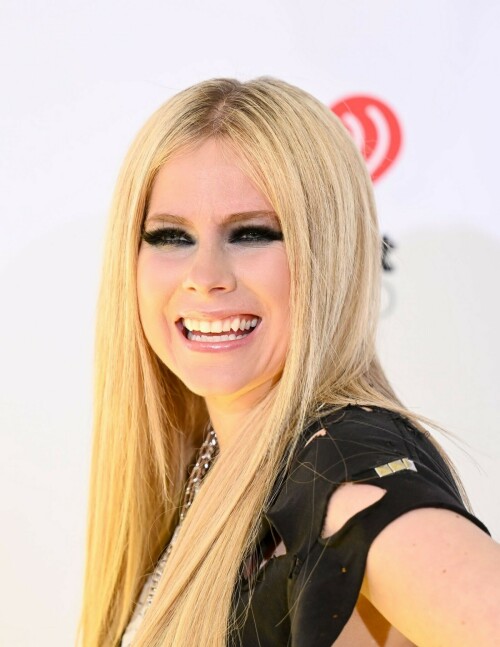 Avril Lavigne | 2024 iHeartRadio Music Awards, Los Angeles - 01.04.2024

Avril Lavigne brings her signature punk-rock style to iHeartRadio Awards in a shredded Green Day T-shirt

Avril Lavigne arrived at the 2024 iHeartRadio Awards in an all-black outfit.

For Monday's awards show, held in Los Angeles, the 39-year-old music sensation styled a shredded black Green Day T-shirt with parachute pants.

The Canadian pop star added height to her petite frame with lace-up boots that had a chunky heel.

Lavigne, who rose to fame at age 17, hit the red carpet with heavy eye makeup as she layered rings of black liner.

Her long, bright blonde locks were styled in a deep center part and ironed straight as they flowed over her chest.

Avril flaunted a lengthy, matte black manicure and flashed her tattooed arms as she posed for photos.

She layered glinty silver-toned chains around her neck, including a smaller one with a locket.

The hitmaker also stacked multiple bracelets on her left wrist as she flashed her megawatt smile.

Missing from the scene was her new boyfriend Nate Smith, who she was first spotted with earlier this year.

Cher is set to receive an Icon Award at the ceremony, which is being held at the Dolby Theatre in Hollywood.

iHeart is 'honoring her unparalleled contributions to music and pop culture for over seven decades,' per a press release.

Cher, who had hits dating back to the 1960s with I Got You Babe and was on the popular The Sonny & Cher Comedy Hour in the 1970s, is the only artist to have a number one single on a Billboard chart for seven consecutive decades.

Justin Timberlake and Jelly Roll are among the performers hitting the stage for the show.

Green Day, TLC, Lainey Wilson and Tate McRae will also sing at the star-studded event, which airs on Fox from 8 to 10 p.m. ET.

The nominations were announced in mid January.

Taylor Swift, Jelly Roll, 21 Savage, SZA and Olivia Rodrigo lead with most nominations.

Airing LIVE on FOX, the event also will be heard on iHeartRadio stations nationwide and on the iHeartRadio app.

Artists receiving multiple nominations include, 21 Savage, Beyoncé, Billie Eilish, Blink-182, Carin León, David Kushner, Doechii, Doja Cat, Drake, Dua Lipa, Fall Out Boy, Foo Fighters, Grupo Frontera, Ice Spice, Jelly Roll.

DailyMail

#AvrilLavigne