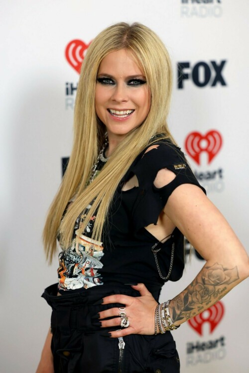 Avril Lavigne | 2024 iHeartRadio Music Awards, Los Angeles - 01.04.2024

Avril Lavigne brings her signature punk-rock style to iHeartRadio Awards in a shredded Green Day T-shirt

Avril Lavigne arrived at the 2024 iHeartRadio Awards in an all-black outfit.

For Monday's awards show, held in Los Angeles, the 39-year-old music sensation styled a shredded black Green Day T-shirt with parachute pants.

The Canadian pop star added height to her petite frame with lace-up boots that had a chunky heel.

Lavigne, who rose to fame at age 17, hit the red carpet with heavy eye makeup as she layered rings of black liner.

Her long, bright blonde locks were styled in a deep center part and ironed straight as they flowed over her chest.

Avril flaunted a lengthy, matte black manicure and flashed her tattooed arms as she posed for photos.

She layered glinty silver-toned chains around her neck, including a smaller one with a locket.

The hitmaker also stacked multiple bracelets on her left wrist as she flashed her megawatt smile.

Missing from the scene was her new boyfriend Nate Smith, who she was first spotted with earlier this year.

Cher is set to receive an Icon Award at the ceremony, which is being held at the Dolby Theatre in Hollywood.

iHeart is 'honoring her unparalleled contributions to music and pop culture for over seven decades,' per a press release.

Cher, who had hits dating back to the 1960s with I Got You Babe and was on the popular The Sonny & Cher Comedy Hour in the 1970s, is the only artist to have a number one single on a Billboard chart for seven consecutive decades.

Justin Timberlake and Jelly Roll are among the performers hitting the stage for the show.

Green Day, TLC, Lainey Wilson and Tate McRae will also sing at the star-studded event, which airs on Fox from 8 to 10 p.m. ET.

The nominations were announced in mid January.

Taylor Swift, Jelly Roll, 21 Savage, SZA and Olivia Rodrigo lead with most nominations.

Airing LIVE on FOX, the event also will be heard on iHeartRadio stations nationwide and on the iHeartRadio app.

Artists receiving multiple nominations include, 21 Savage, Beyoncé, Billie Eilish, Blink-182, Carin León, David Kushner, Doechii, Doja Cat, Drake, Dua Lipa, Fall Out Boy, Foo Fighters, Grupo Frontera, Ice Spice, Jelly Roll.

DailyMail

#AvrilLavigne