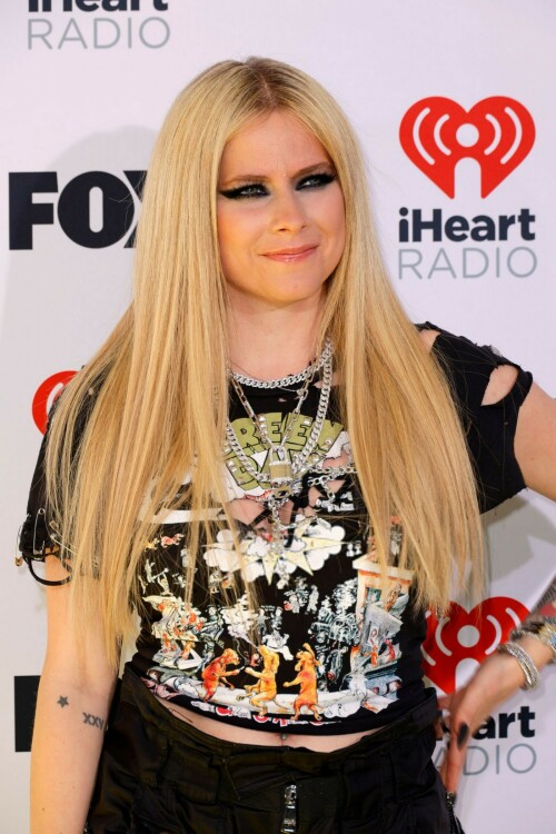 Avril Lavigne | 2024 iHeartRadio Music Awards, Los Angeles - 01.04.2024

Avril Lavigne brings her signature punk-rock style to iHeartRadio Awards in a shredded Green Day T-shirt

Avril Lavigne arrived at the 2024 iHeartRadio Awards in an all-black outfit.

For Monday's awards show, held in Los Angeles, the 39-year-old music sensation styled a shredded black Green Day T-shirt with parachute pants.

The Canadian pop star added height to her petite frame with lace-up boots that had a chunky heel.

Lavigne, who rose to fame at age 17, hit the red carpet with heavy eye makeup as she layered rings of black liner.

Her long, bright blonde locks were styled in a deep center part and ironed straight as they flowed over her chest.

Avril flaunted a lengthy, matte black manicure and flashed her tattooed arms as she posed for photos.

She layered glinty silver-toned chains around her neck, including a smaller one with a locket.

The hitmaker also stacked multiple bracelets on her left wrist as she flashed her megawatt smile.

Missing from the scene was her new boyfriend Nate Smith, who she was first spotted with earlier this year.

Cher is set to receive an Icon Award at the ceremony, which is being held at the Dolby Theatre in Hollywood.

iHeart is 'honoring her unparalleled contributions to music and pop culture for over seven decades,' per a press release.

Cher, who had hits dating back to the 1960s with I Got You Babe and was on the popular The Sonny & Cher Comedy Hour in the 1970s, is the only artist to have a number one single on a Billboard chart for seven consecutive decades.

Justin Timberlake and Jelly Roll are among the performers hitting the stage for the show.

Green Day, TLC, Lainey Wilson and Tate McRae will also sing at the star-studded event, which airs on Fox from 8 to 10 p.m. ET.

The nominations were announced in mid January.

Taylor Swift, Jelly Roll, 21 Savage, SZA and Olivia Rodrigo lead with most nominations.

Airing LIVE on FOX, the event also will be heard on iHeartRadio stations nationwide and on the iHeartRadio app.

Artists receiving multiple nominations include, 21 Savage, Beyoncé, Billie Eilish, Blink-182, Carin León, David Kushner, Doechii, Doja Cat, Drake, Dua Lipa, Fall Out Boy, Foo Fighters, Grupo Frontera, Ice Spice, Jelly Roll.

DailyMail

#AvrilLavigne