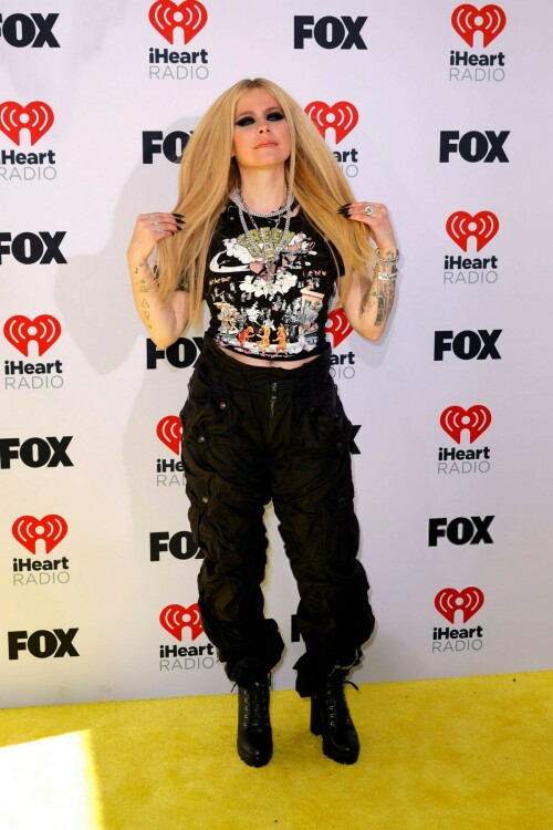 Avril Lavigne | 2024 iHeartRadio Music Awards, Los Angeles - 01.04.2024

Avril Lavigne brings her signature punk-rock style to iHeartRadio Awards in a shredded Green Day T-shirt

Avril Lavigne arrived at the 2024 iHeartRadio Awards in an all-black outfit.

For Monday's awards show, held in Los Angeles, the 39-year-old music sensation styled a shredded black Green Day T-shirt with parachute pants.

The Canadian pop star added height to her petite frame with lace-up boots that had a chunky heel.

Lavigne, who rose to fame at age 17, hit the red carpet with heavy eye makeup as she layered rings of black liner.

Her long, bright blonde locks were styled in a deep center part and ironed straight as they flowed over her chest.

Avril flaunted a lengthy, matte black manicure and flashed her tattooed arms as she posed for photos.

She layered glinty silver-toned chains around her neck, including a smaller one with a locket.

The hitmaker also stacked multiple bracelets on her left wrist as she flashed her megawatt smile.

Missing from the scene was her new boyfriend Nate Smith, who she was first spotted with earlier this year.

Cher is set to receive an Icon Award at the ceremony, which is being held at the Dolby Theatre in Hollywood.

iHeart is 'honoring her unparalleled contributions to music and pop culture for over seven decades,' per a press release.

Cher, who had hits dating back to the 1960s with I Got You Babe and was on the popular The Sonny & Cher Comedy Hour in the 1970s, is the only artist to have a number one single on a Billboard chart for seven consecutive decades.

Justin Timberlake and Jelly Roll are among the performers hitting the stage for the show.

Green Day, TLC, Lainey Wilson and Tate McRae will also sing at the star-studded event, which airs on Fox from 8 to 10 p.m. ET.

The nominations were announced in mid January.

Taylor Swift, Jelly Roll, 21 Savage, SZA and Olivia Rodrigo lead with most nominations.

Airing LIVE on FOX, the event also will be heard on iHeartRadio stations nationwide and on the iHeartRadio app.

Artists receiving multiple nominations include, 21 Savage, Beyoncé, Billie Eilish, Blink-182, Carin León, David Kushner, Doechii, Doja Cat, Drake, Dua Lipa, Fall Out Boy, Foo Fighters, Grupo Frontera, Ice Spice, Jelly Roll.

DailyMail

#AvrilLavigne